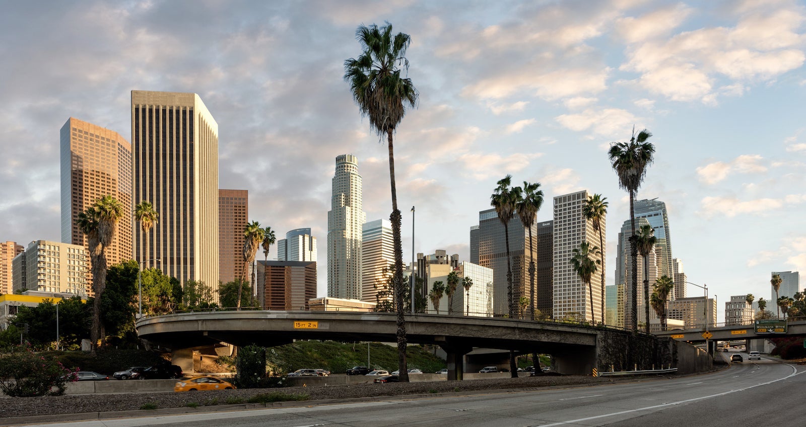 Road By Modern Buildings Against Sky In City During Sunset