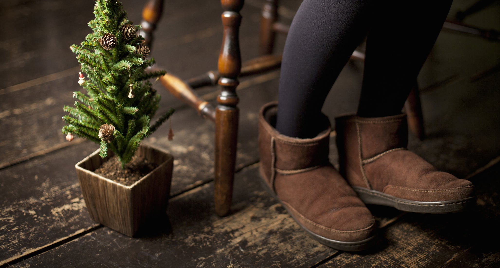 Christmas tree and woman's legs wearing ugg boots