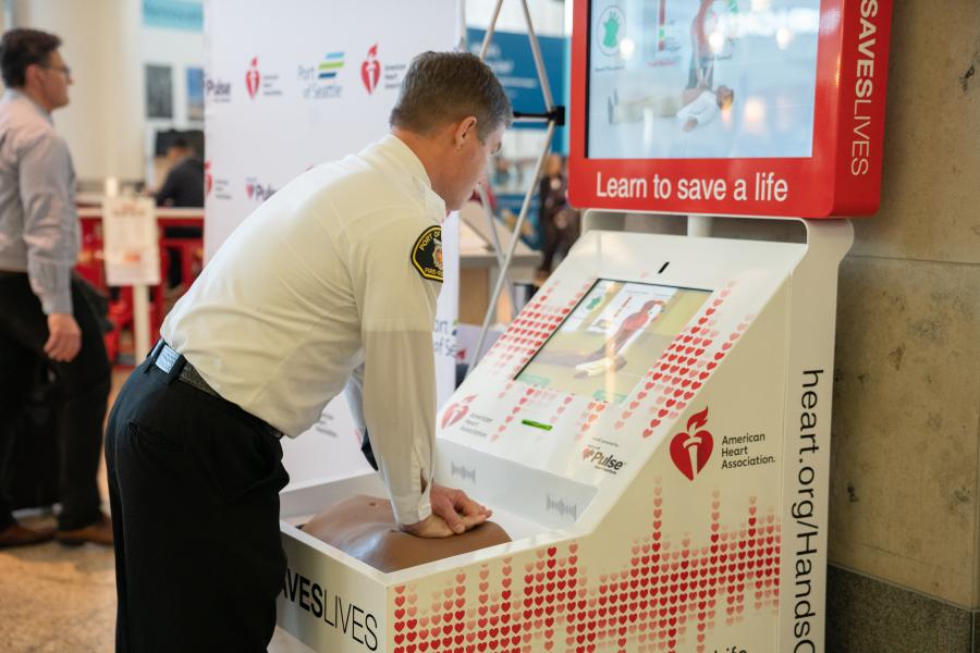 SEA - CHIEF KRAUSE demonstrates how to use the Hands-Only CPR Training Kiosk - Couretsy Port of Seattle