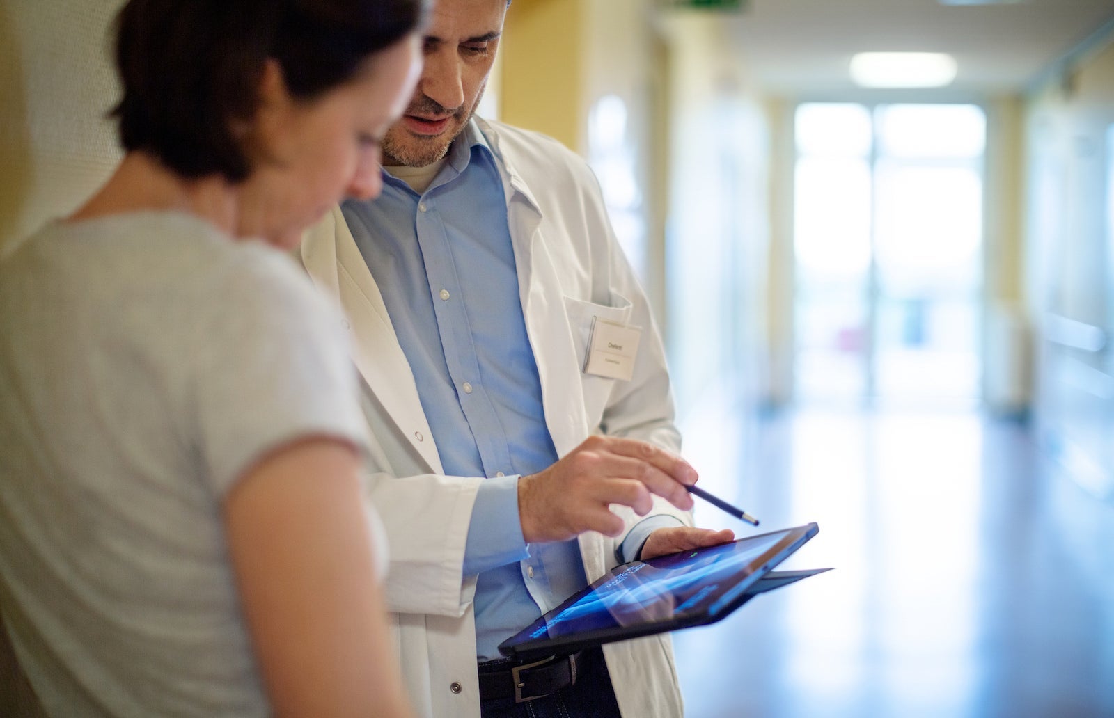 Doctor showing x-ray to a woman patient