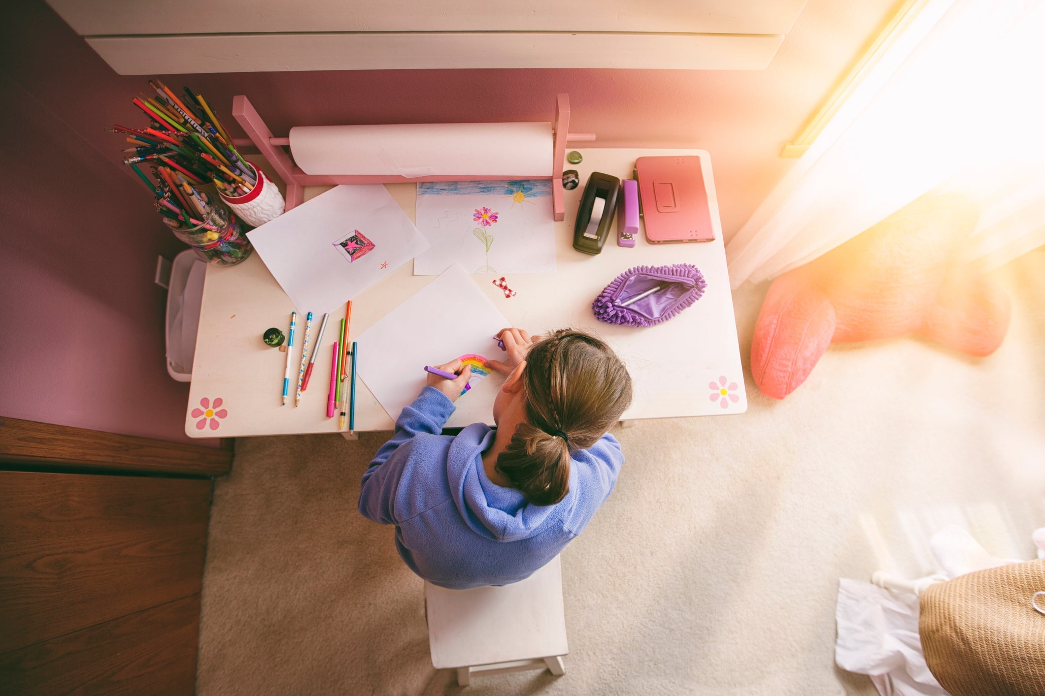 Girl drawing at desk