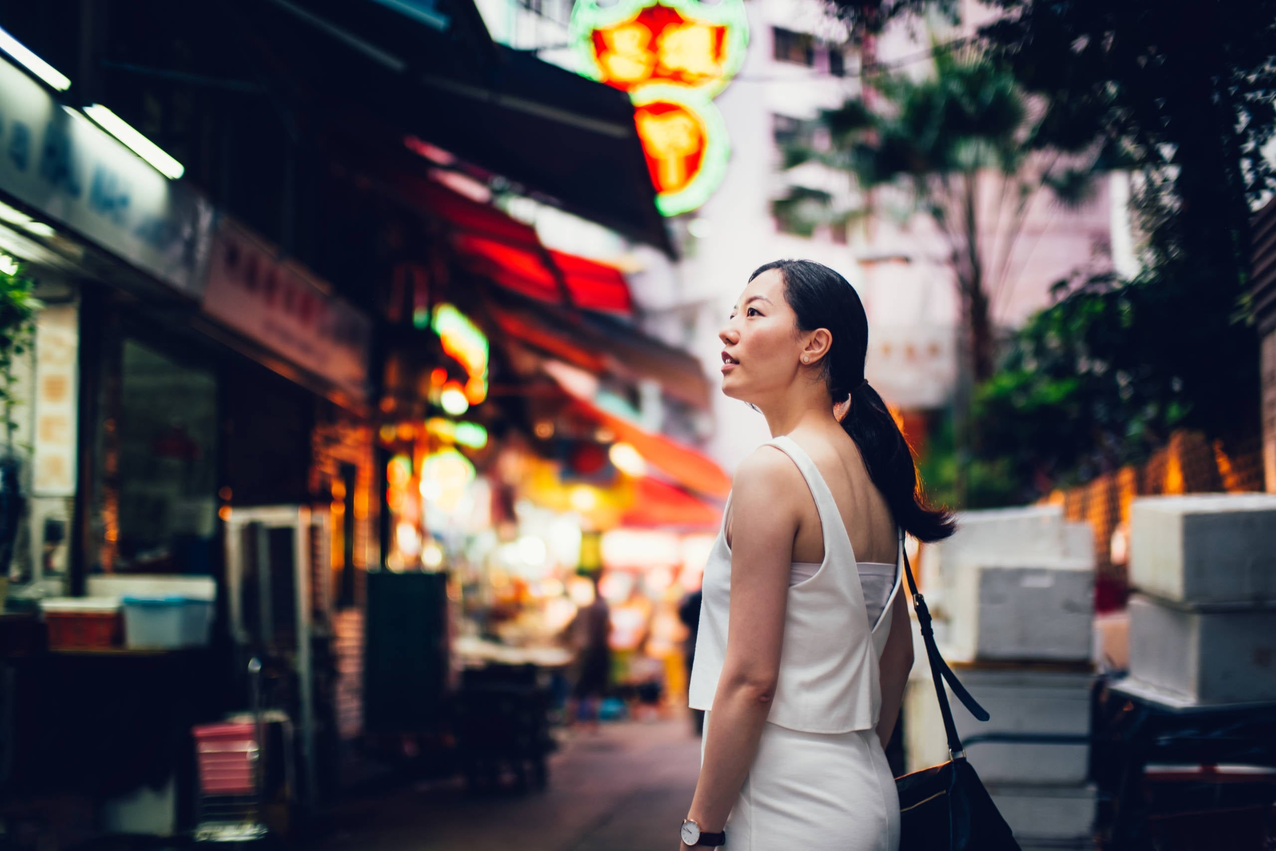 Young female traveller visiting and exploring around in local city street of Hong Kong