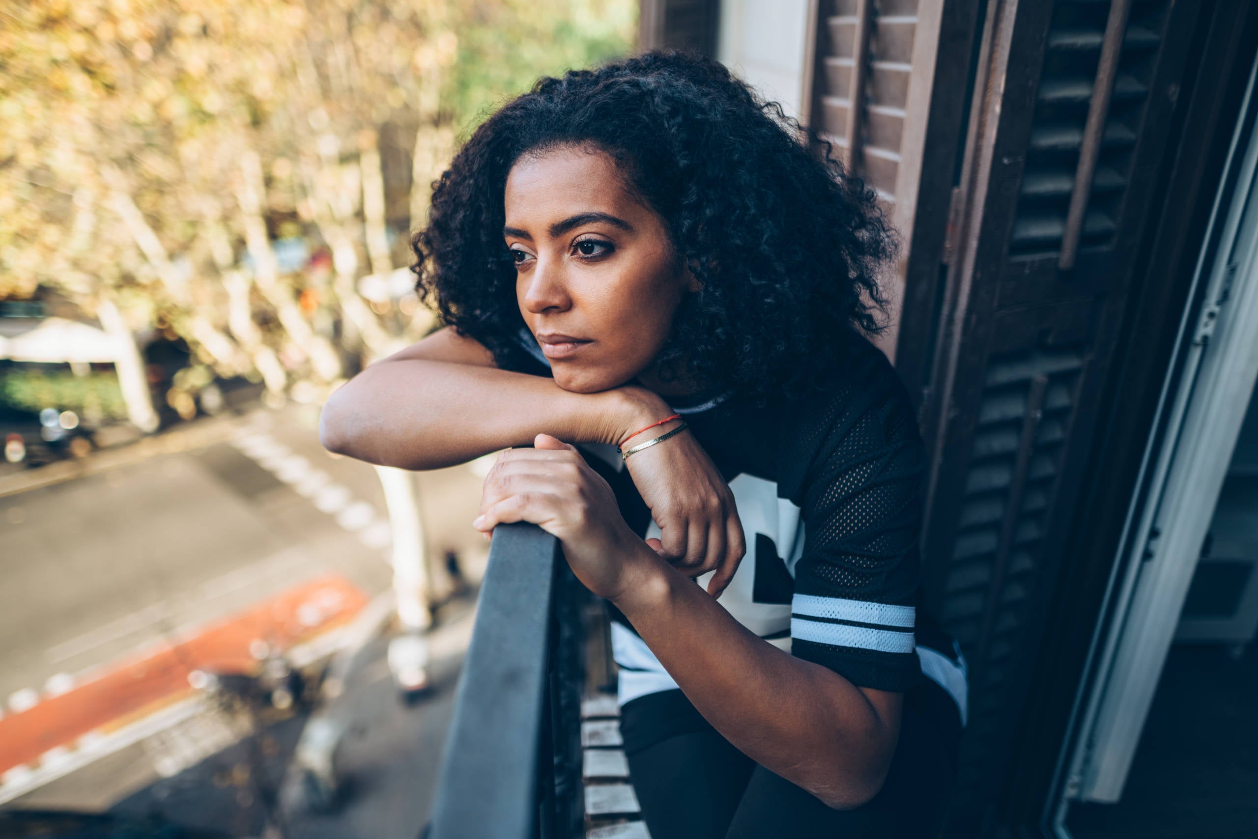 Woman staring out balcony