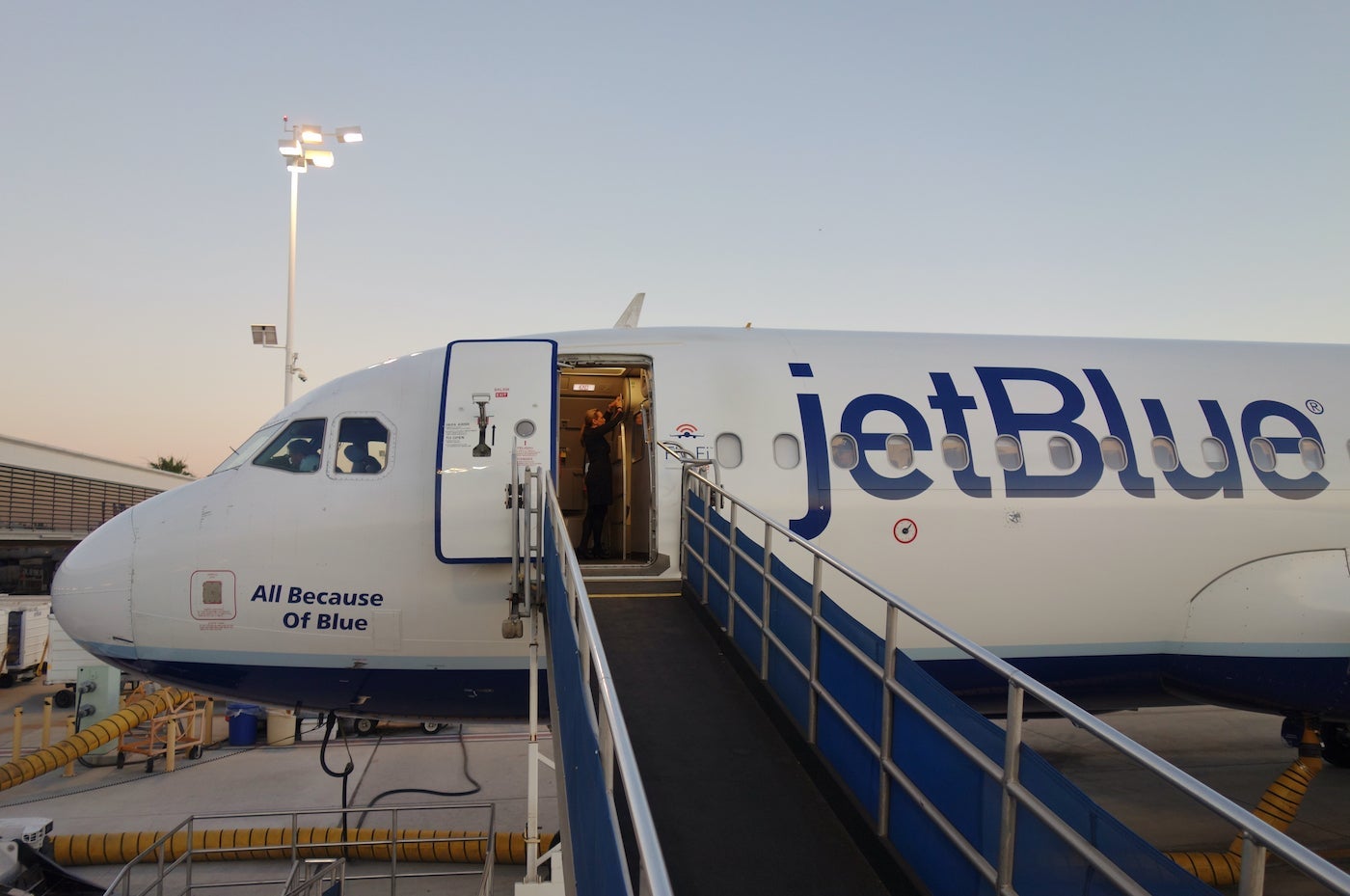 JetBlue plane with a jetbridge attached