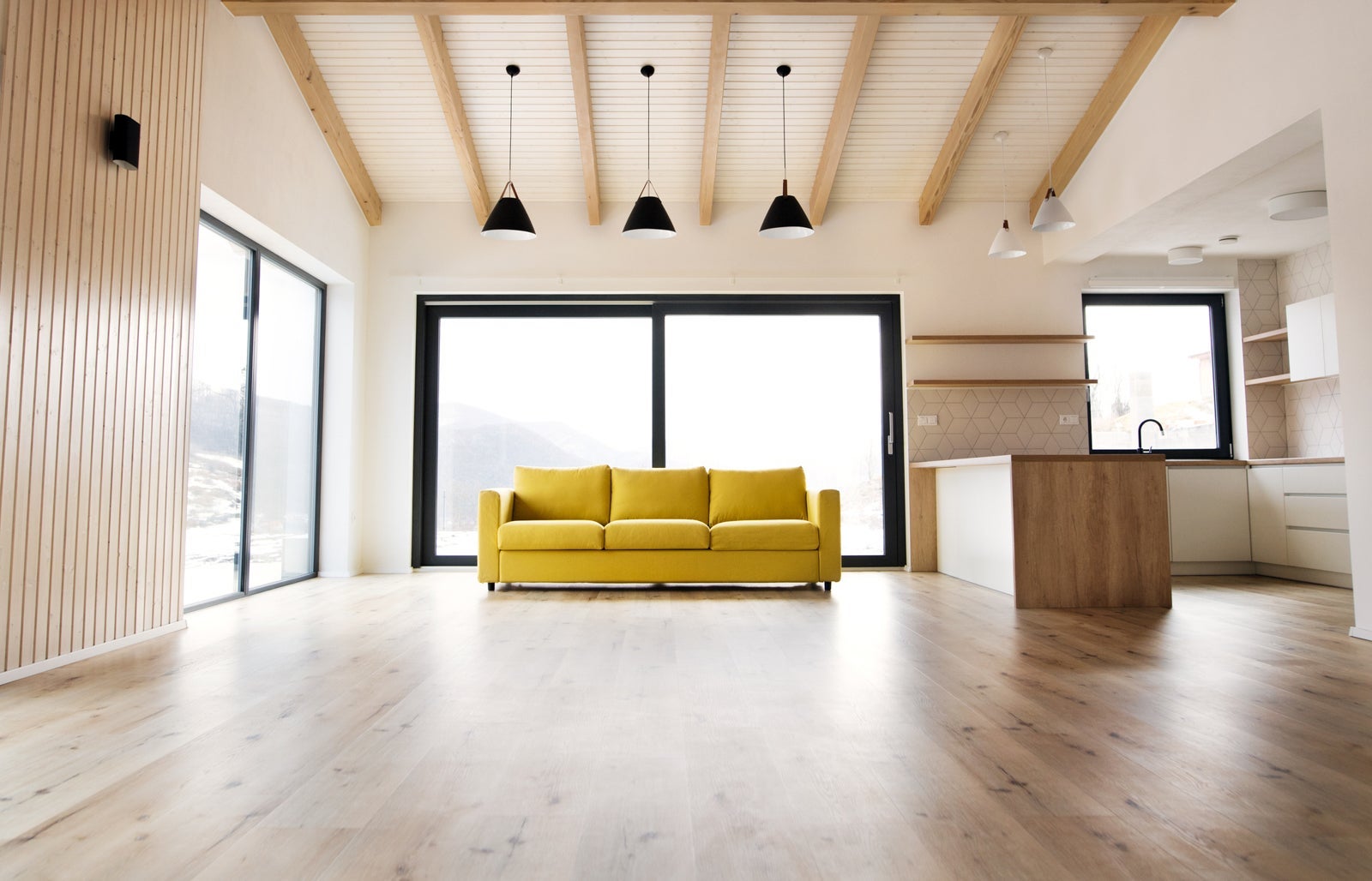 Interior of a modern white empty kitchen and living room.