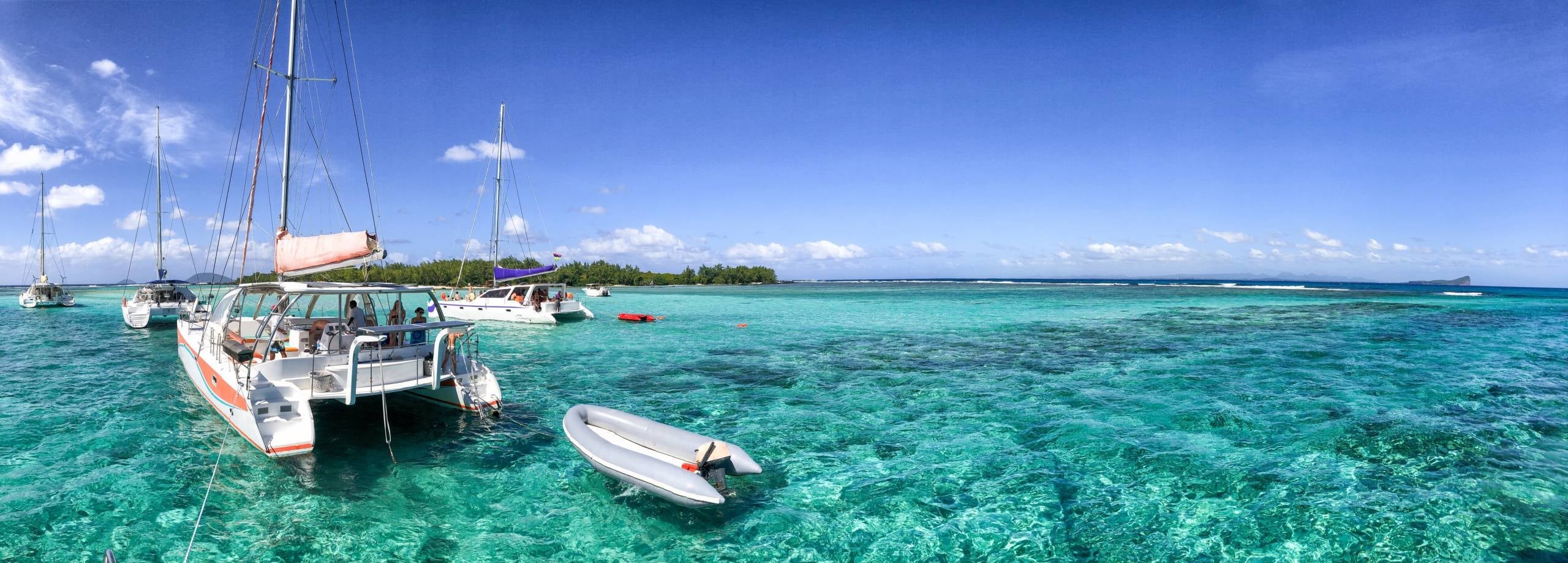 Catamarans anchored near a beautiful beach