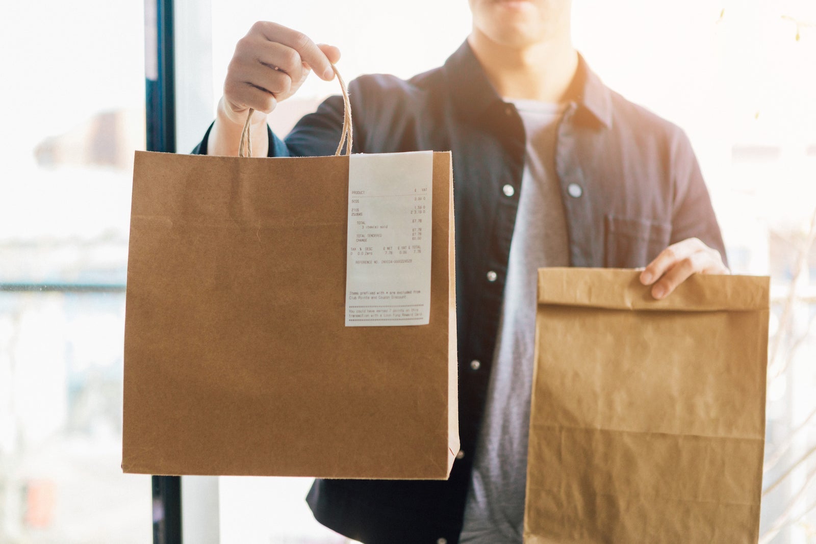 Man Delivering Takeaway Food At The Front Door