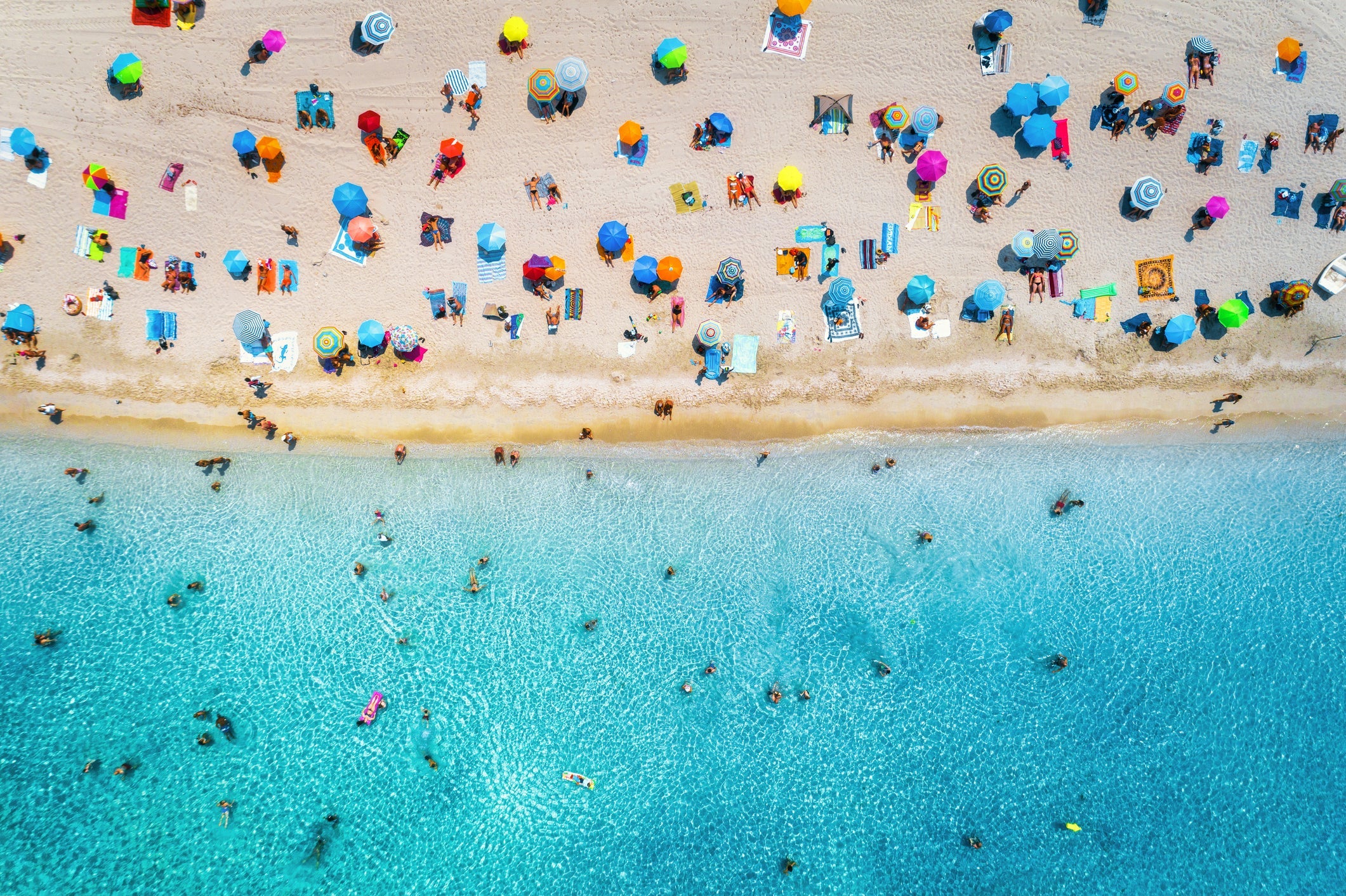 Aerial View Of Sandy Beach With Umbrellas
