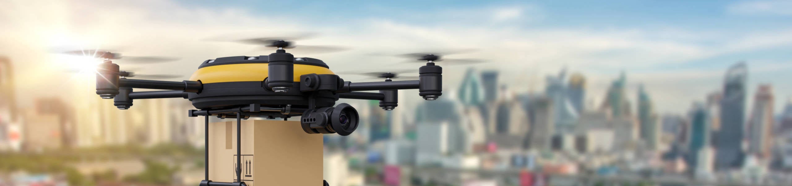 Delivery drone with the package against city background. Fast and convenient transportation concept.
