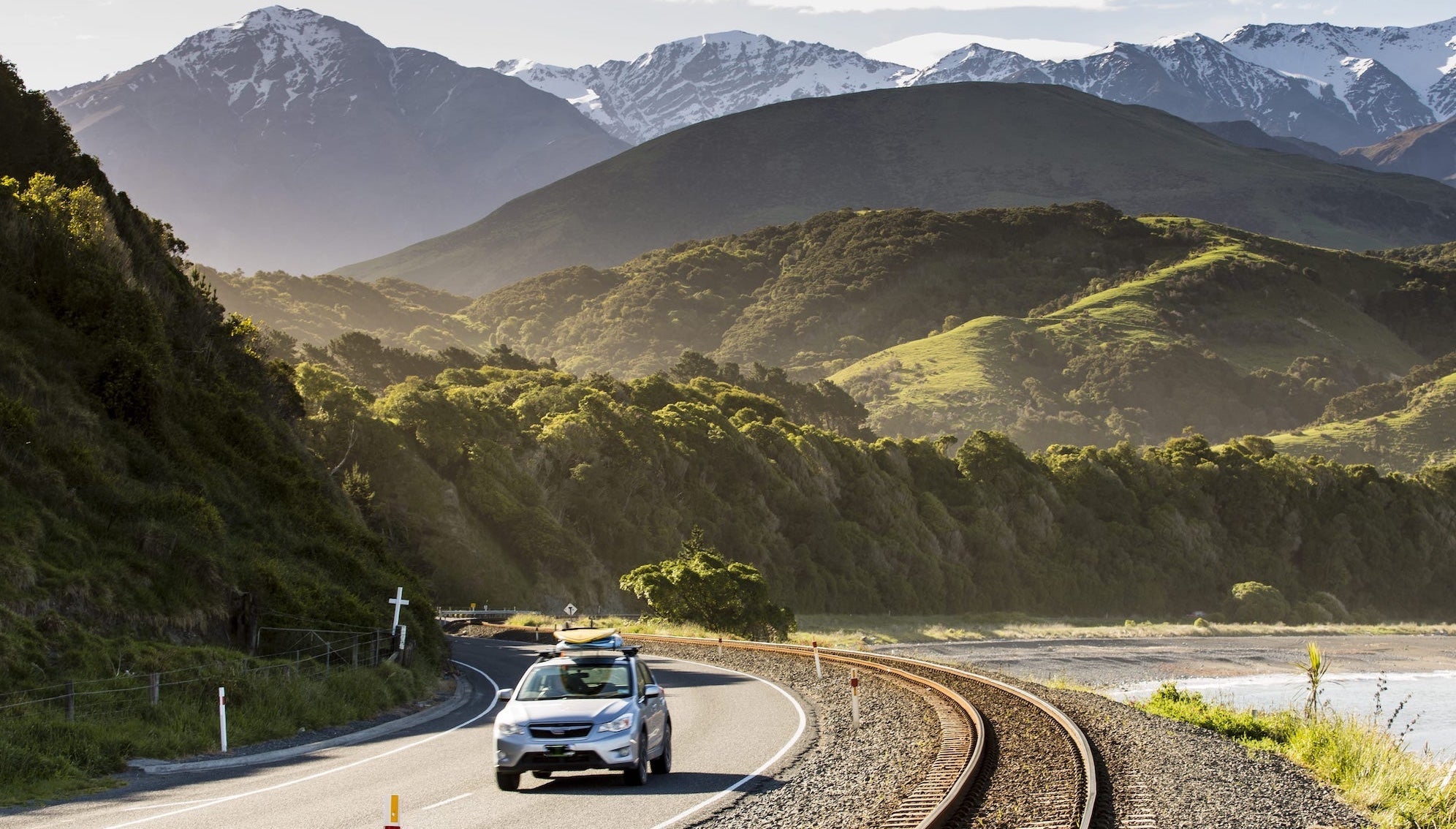 Silver car driving down Kaikoura Highway