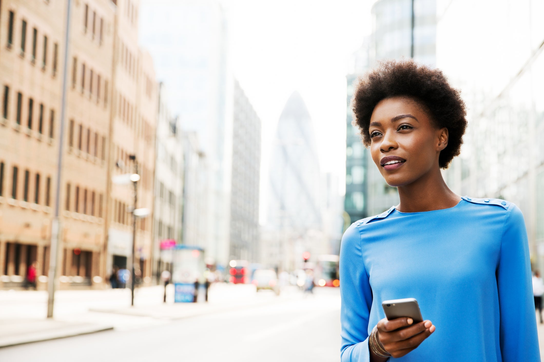 Woman looking ahead with phone