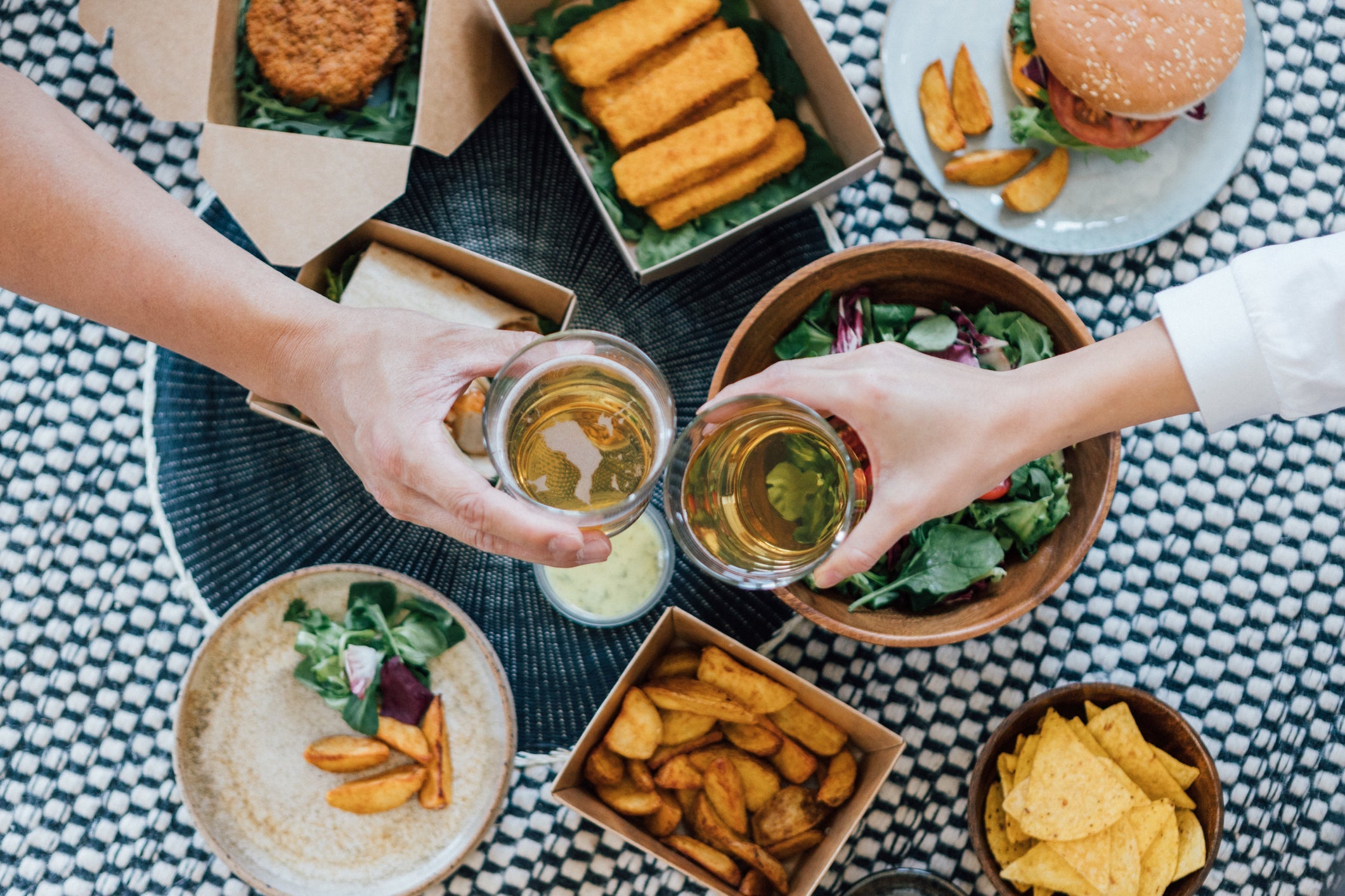 Couple Toasting Beer While Eating Takeaway Food