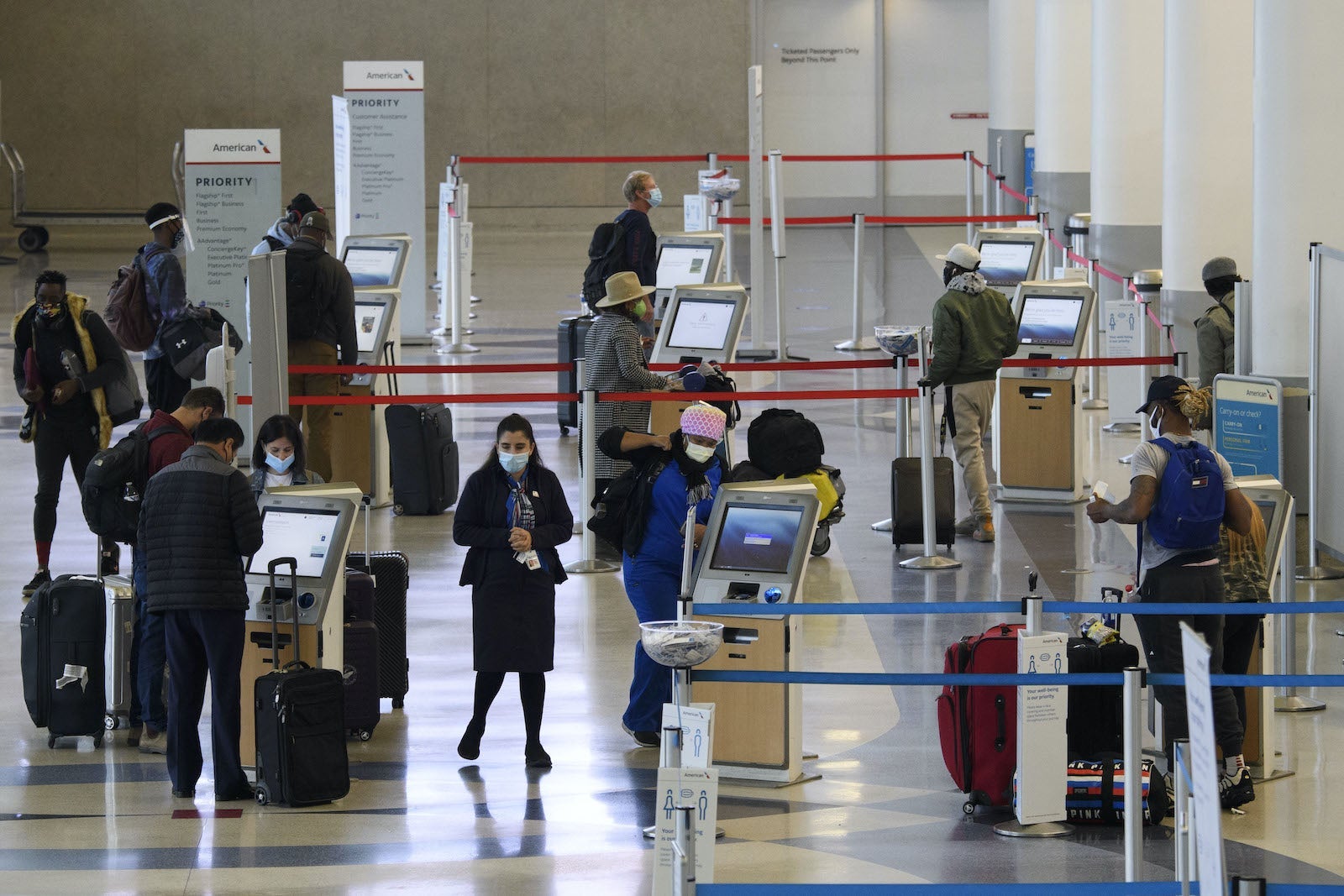 Travelers wearing mask at American Airlines check-in area