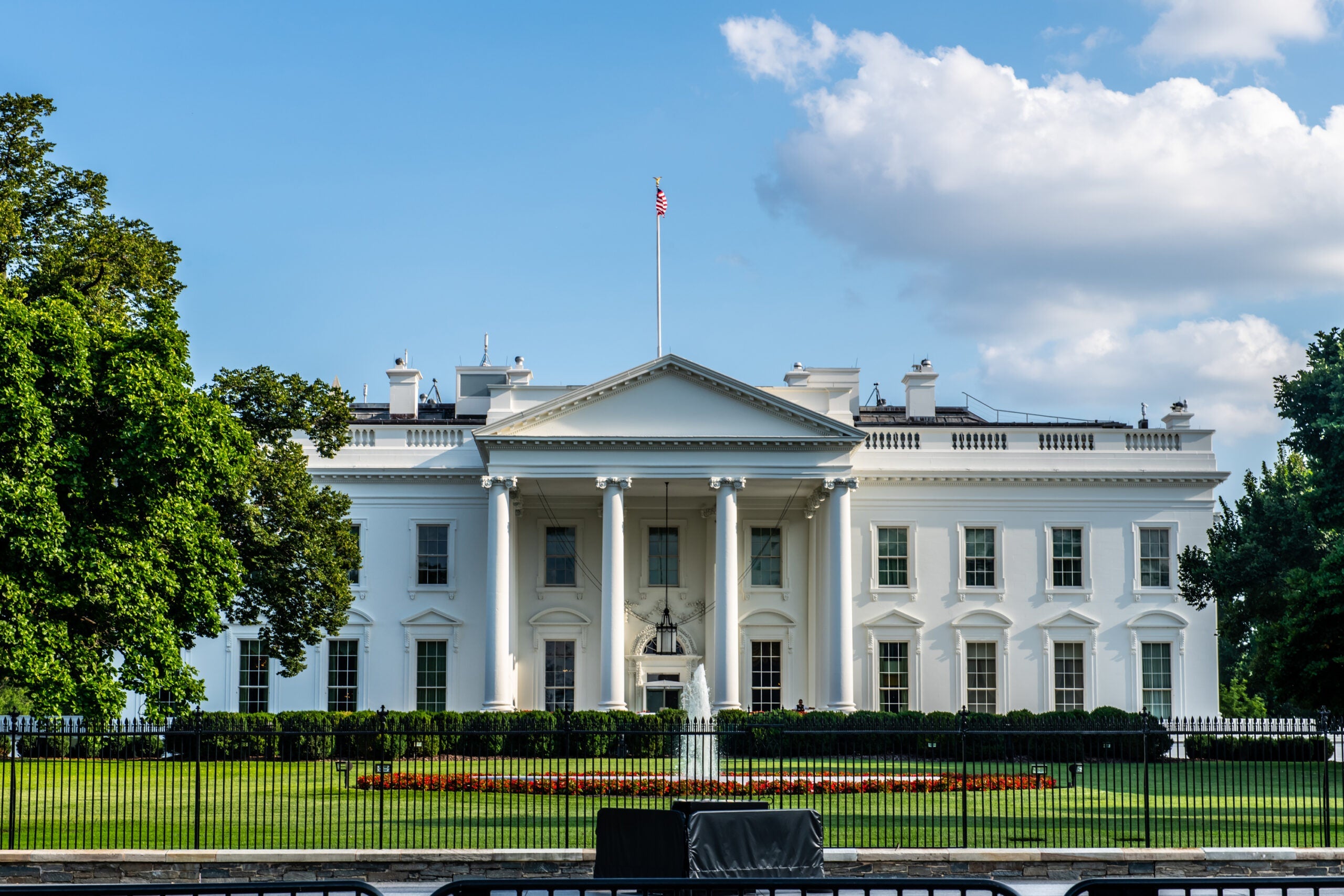 Horizontal color photo of White House in Washington DC on a bright summer day