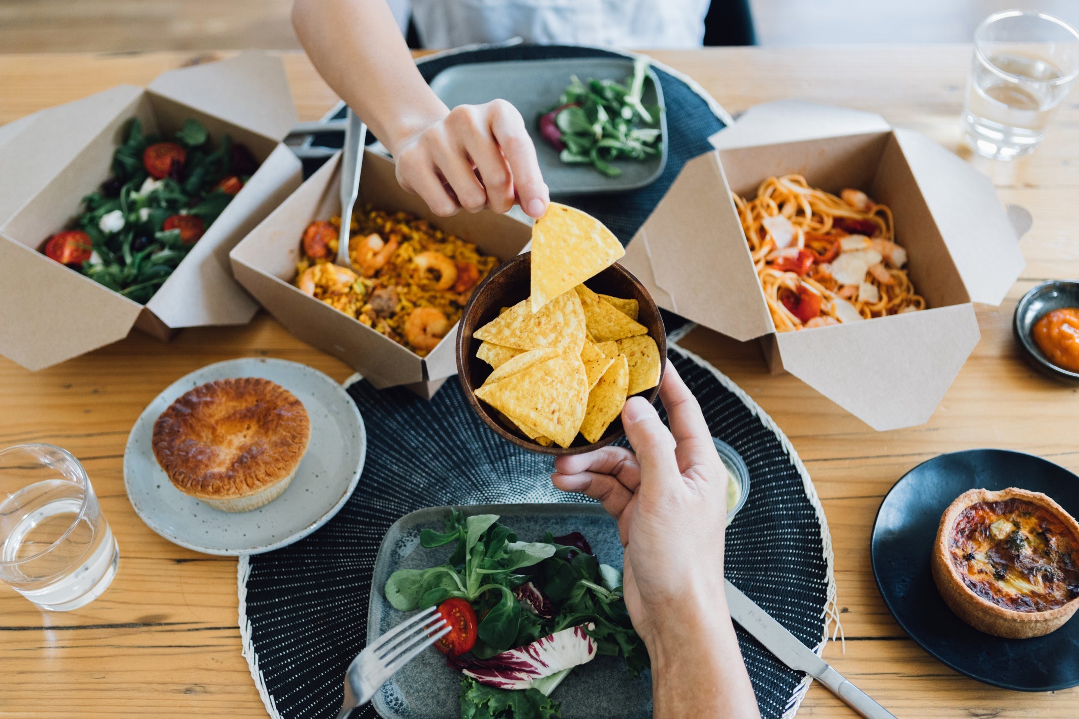 Couple Sharing Takeaway Meal At Dining Table