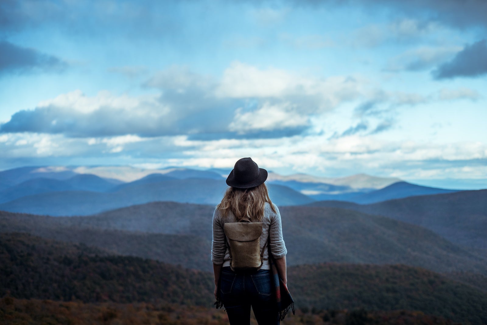 Young woman hiking through beautiful mountains.
