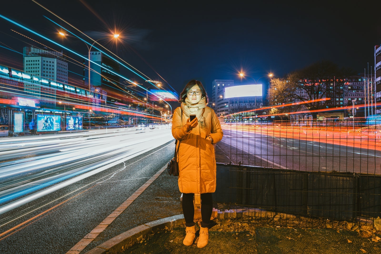 Young Asian Woman Using A Mobile Phone In Downtown District