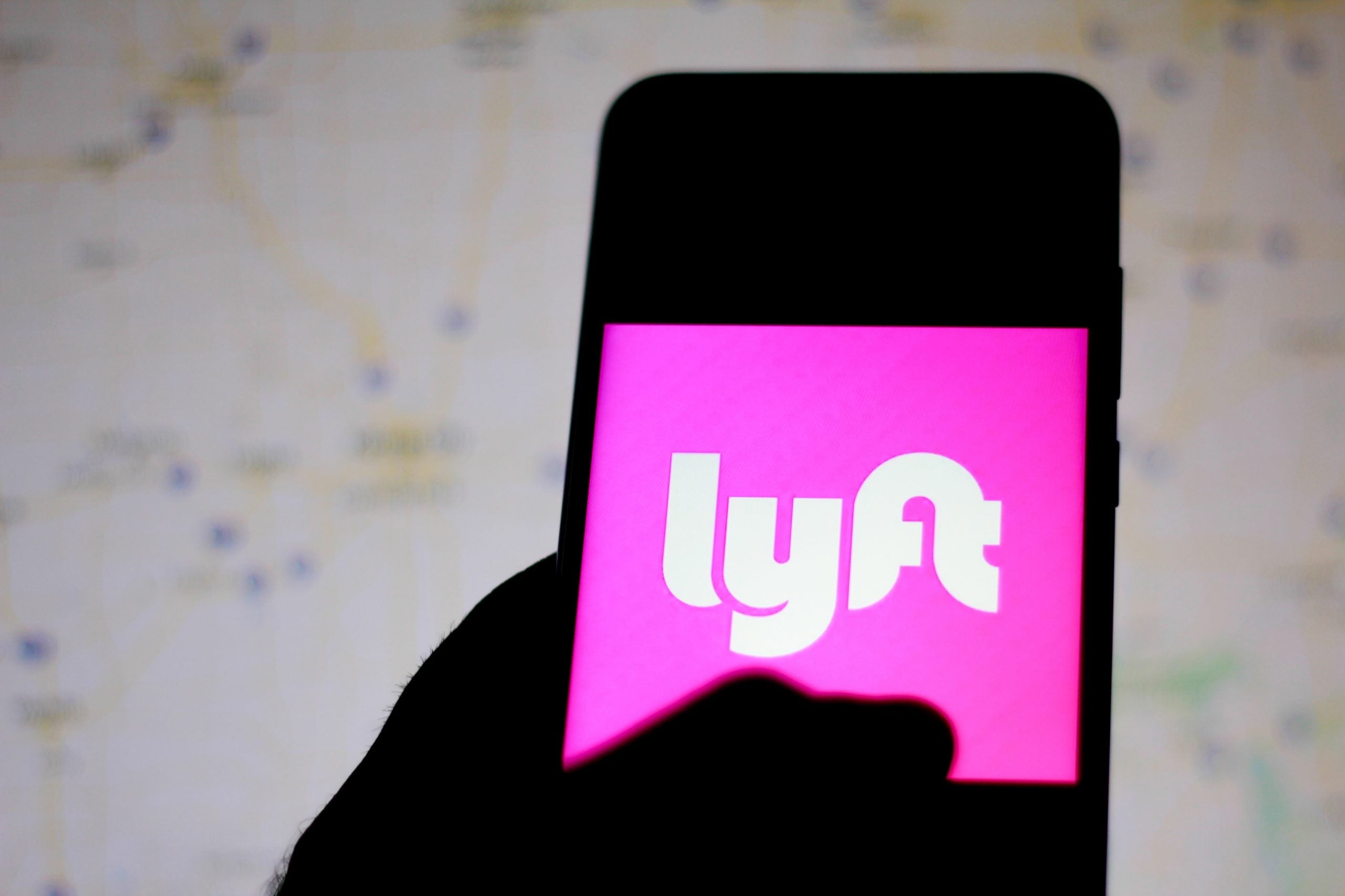 In this photo illustration the Lyft logo is seen displayed