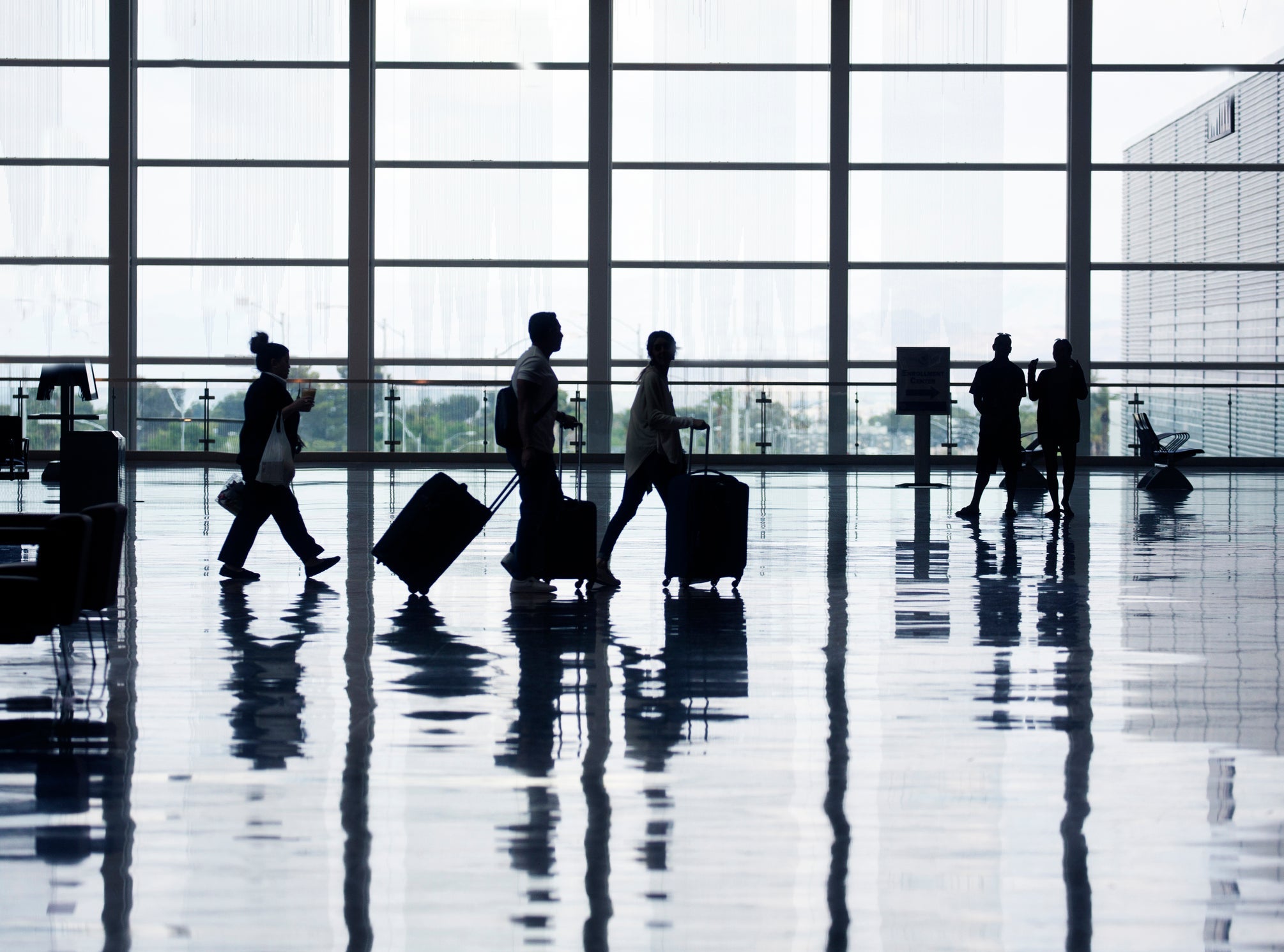 View of airport departures area travellers rushing.