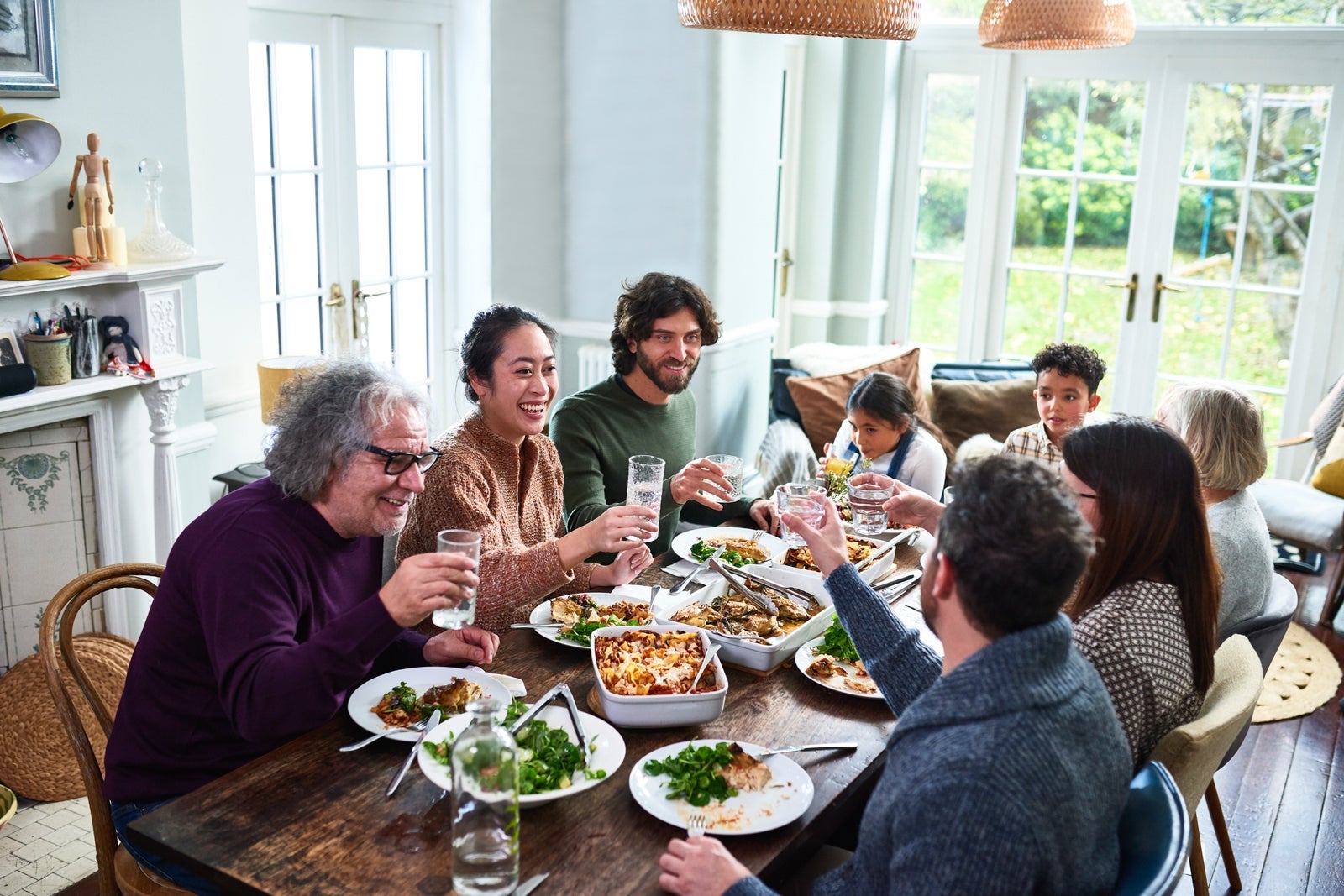 Extended family toasting drinks at lunch
