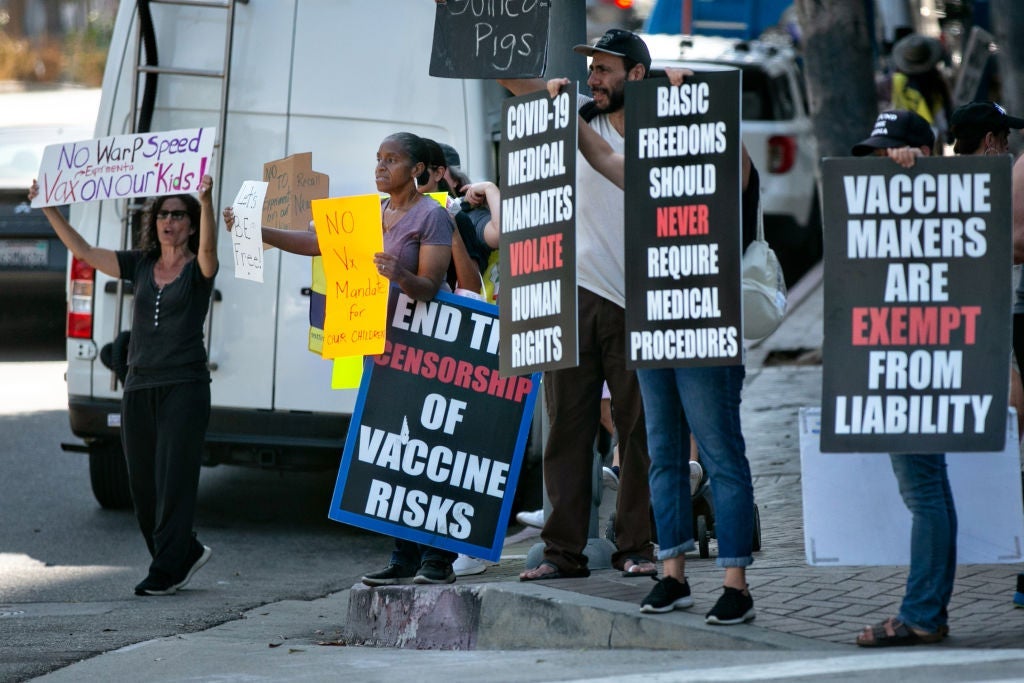 Demonstrators opposed to masking and mandatory vaccination for students gather outside the Los Angeles Unified School District headquarters as board members voted that all children 12 and older in Los Angeles public schools must be fully vaccinated against