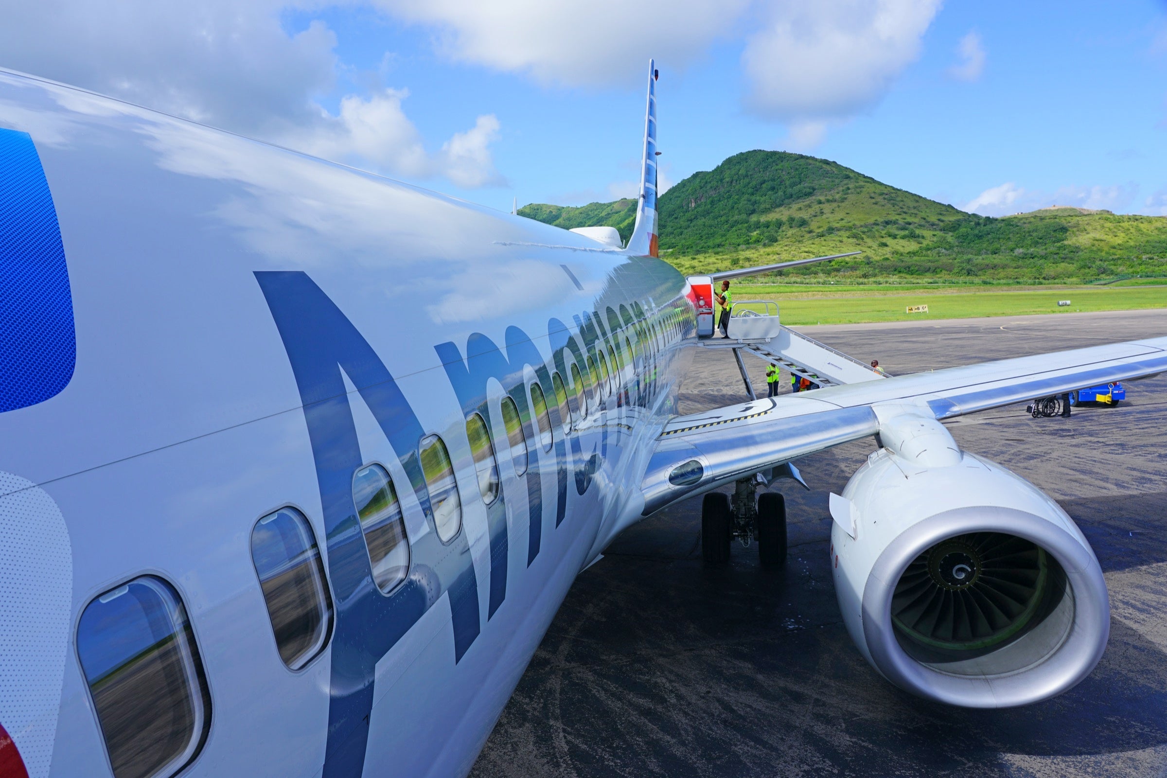 Side of an American Airlines plane with engine and wing