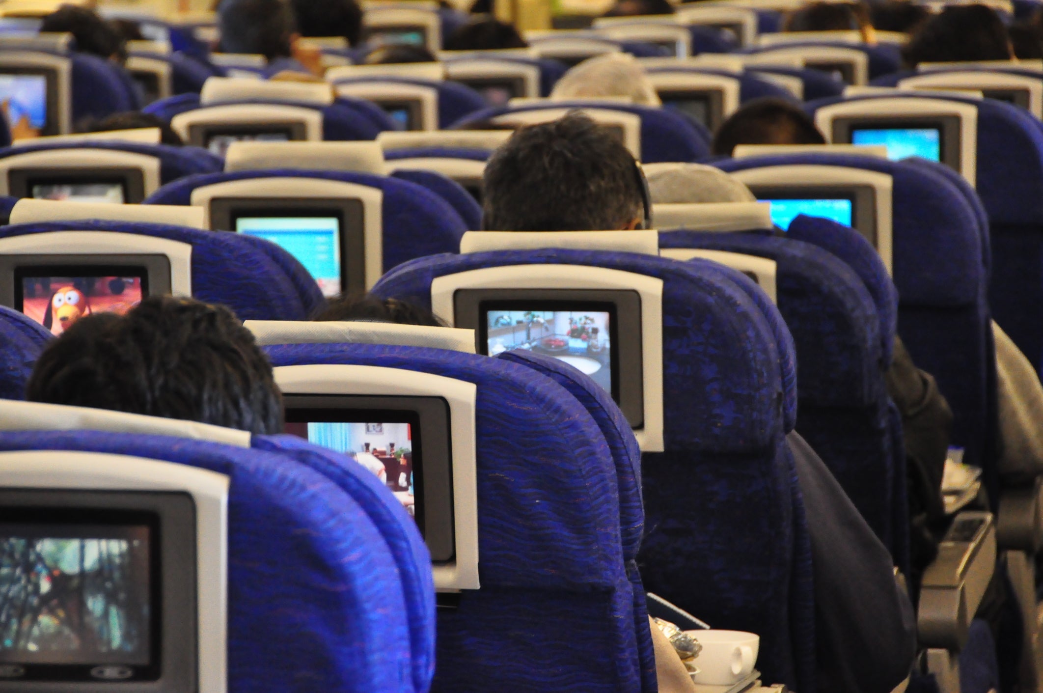 Rear View Of People Sitting In Airplane