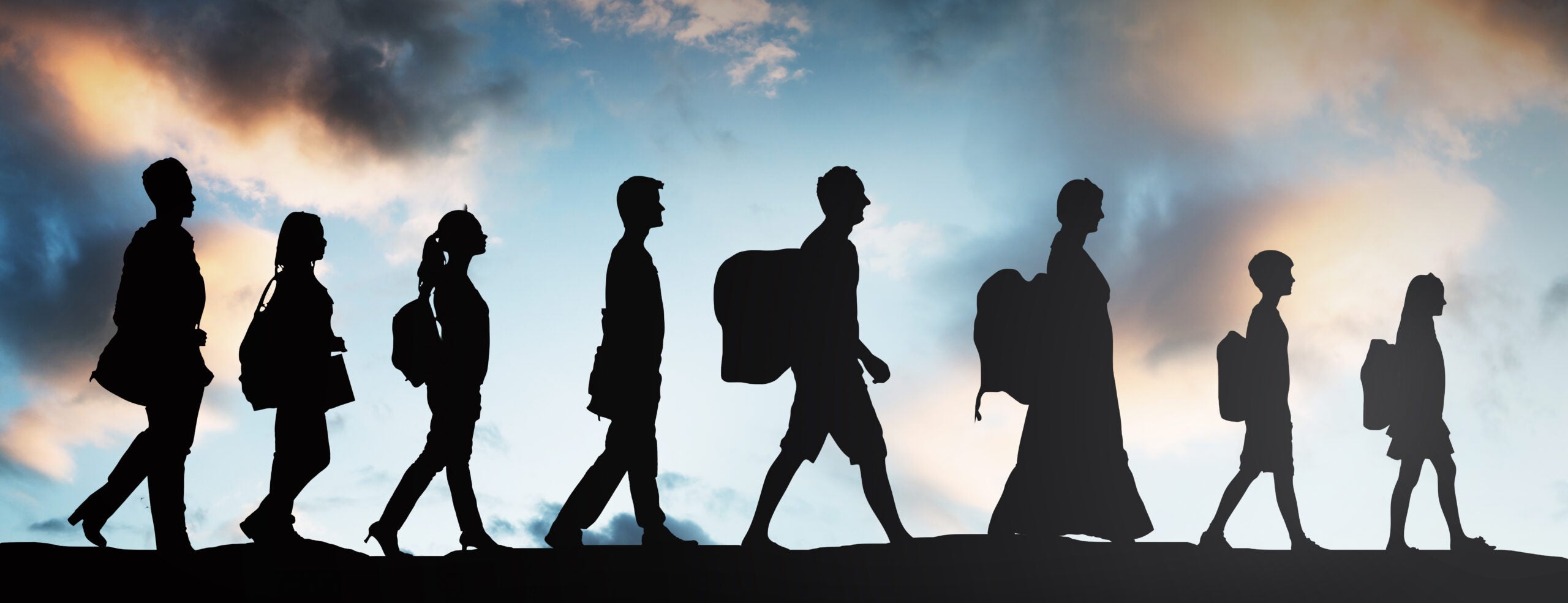 Silhouette,Of,Refugees,People,With,Luggage,Walking,In,A,Row
