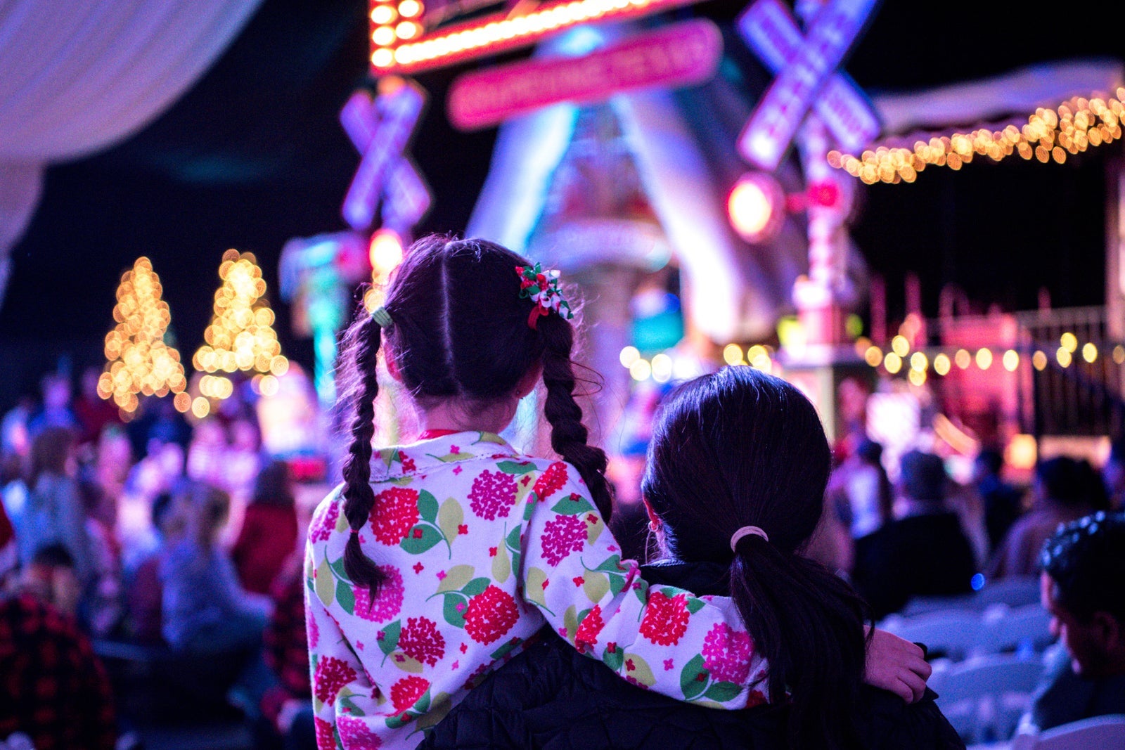 Mother and child are waiting for Santa at a Christmas tree lighting ceremony.