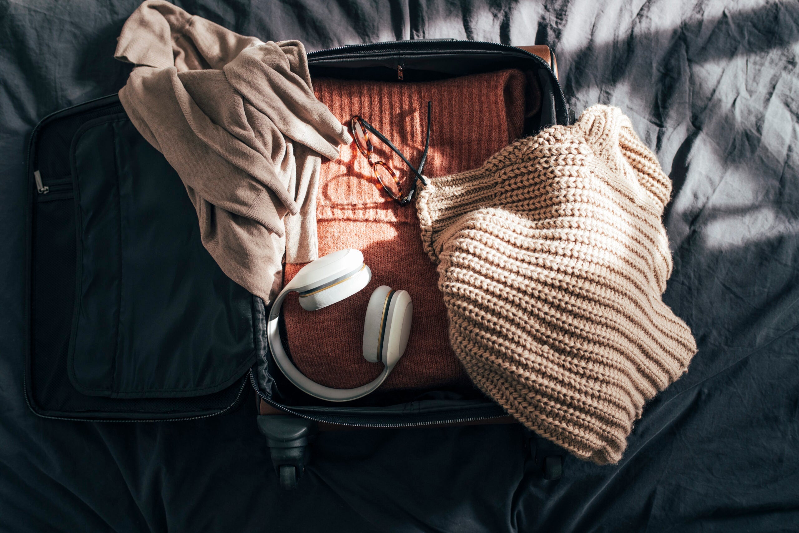 Still life: Packing up Suitcase for Winter Holiday, an Overhead View (Flat Lay)