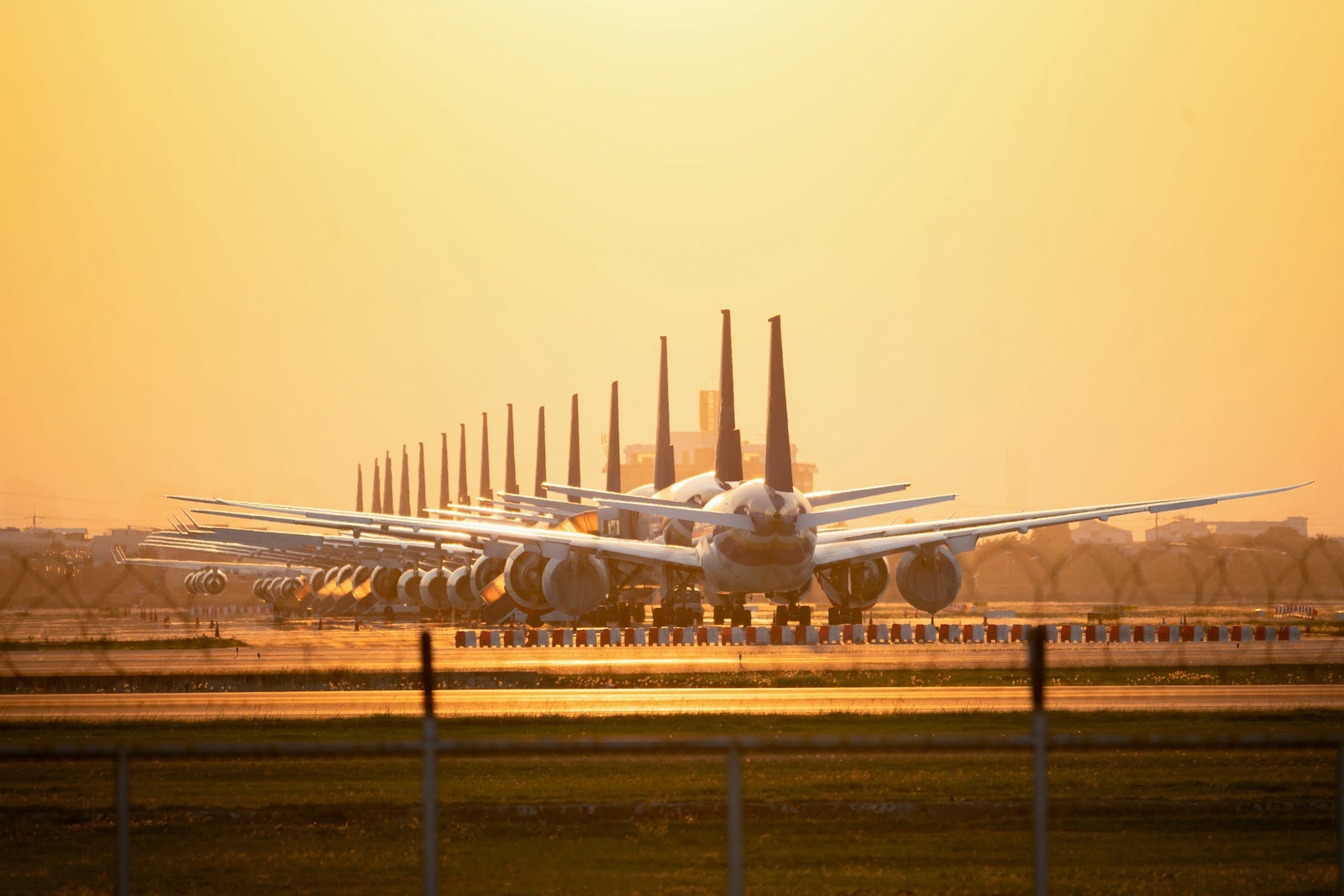 So many airplanes are in line on the runway waiting for take off. These Air Force planes are part of Operation stop service to transport in Covid-19 situation.