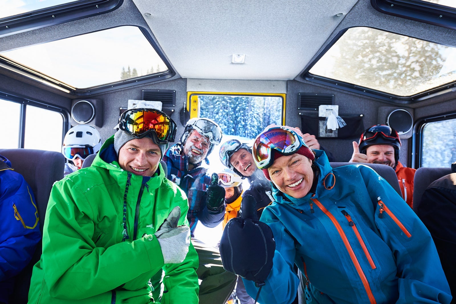 Group portrait of male and female skiers in snow coach, Aspen, Colorado, USA