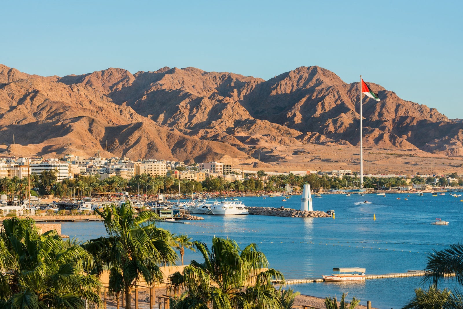 Scenic view of sea and mountains against clear blue sky,Aqaba,Jordan