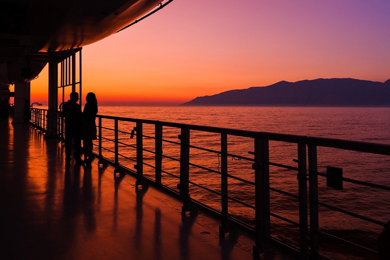 couple on a cruise ship at sunset