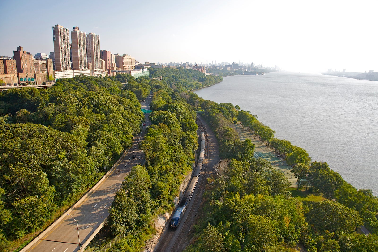 Aerial view of Upper West Side and Riverside Park, with Amtrak train below, from George Washington Bridge, New York, NY, U.S.A.
