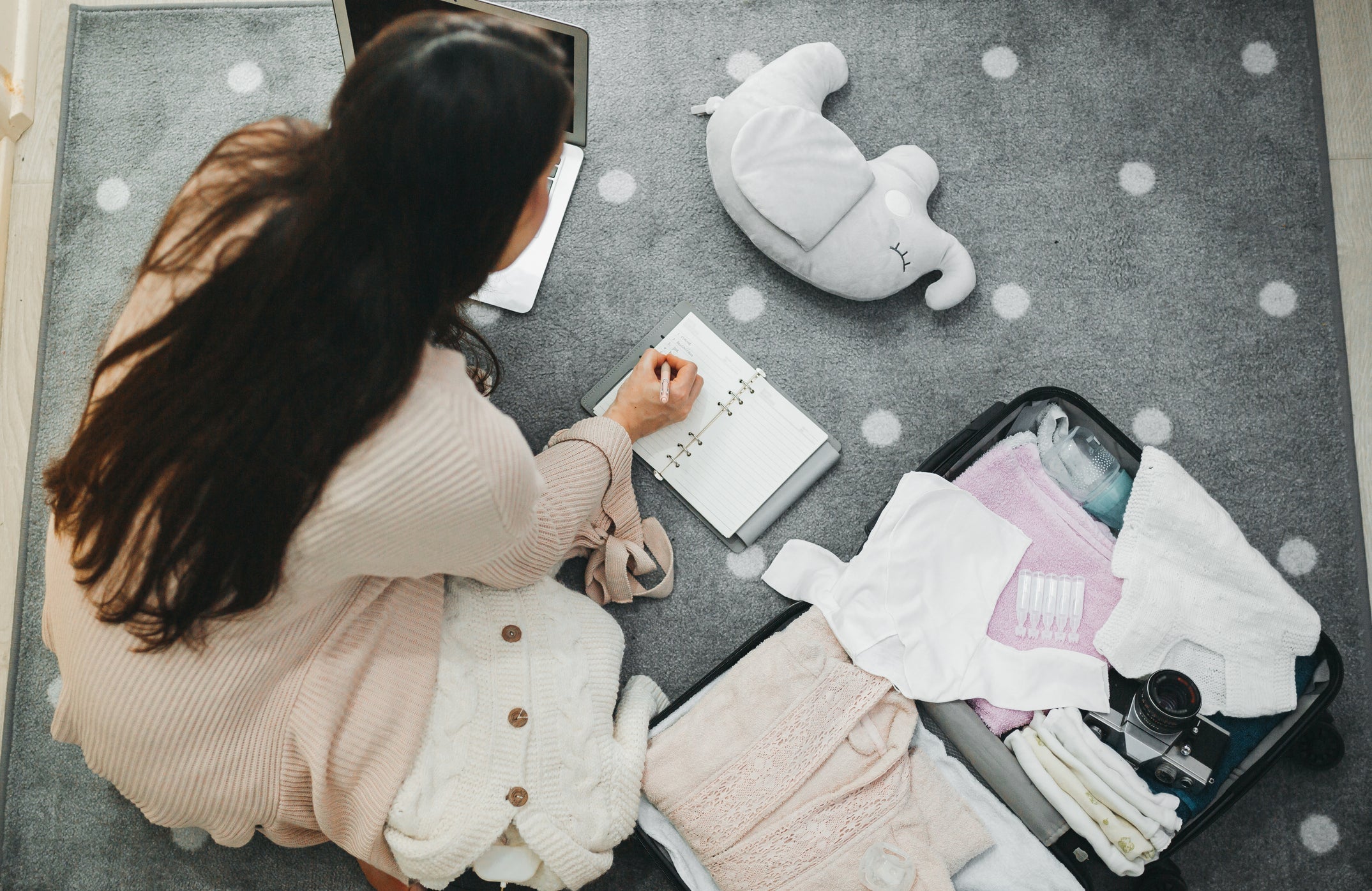 A pregnant woman prepares a bag for the hospital