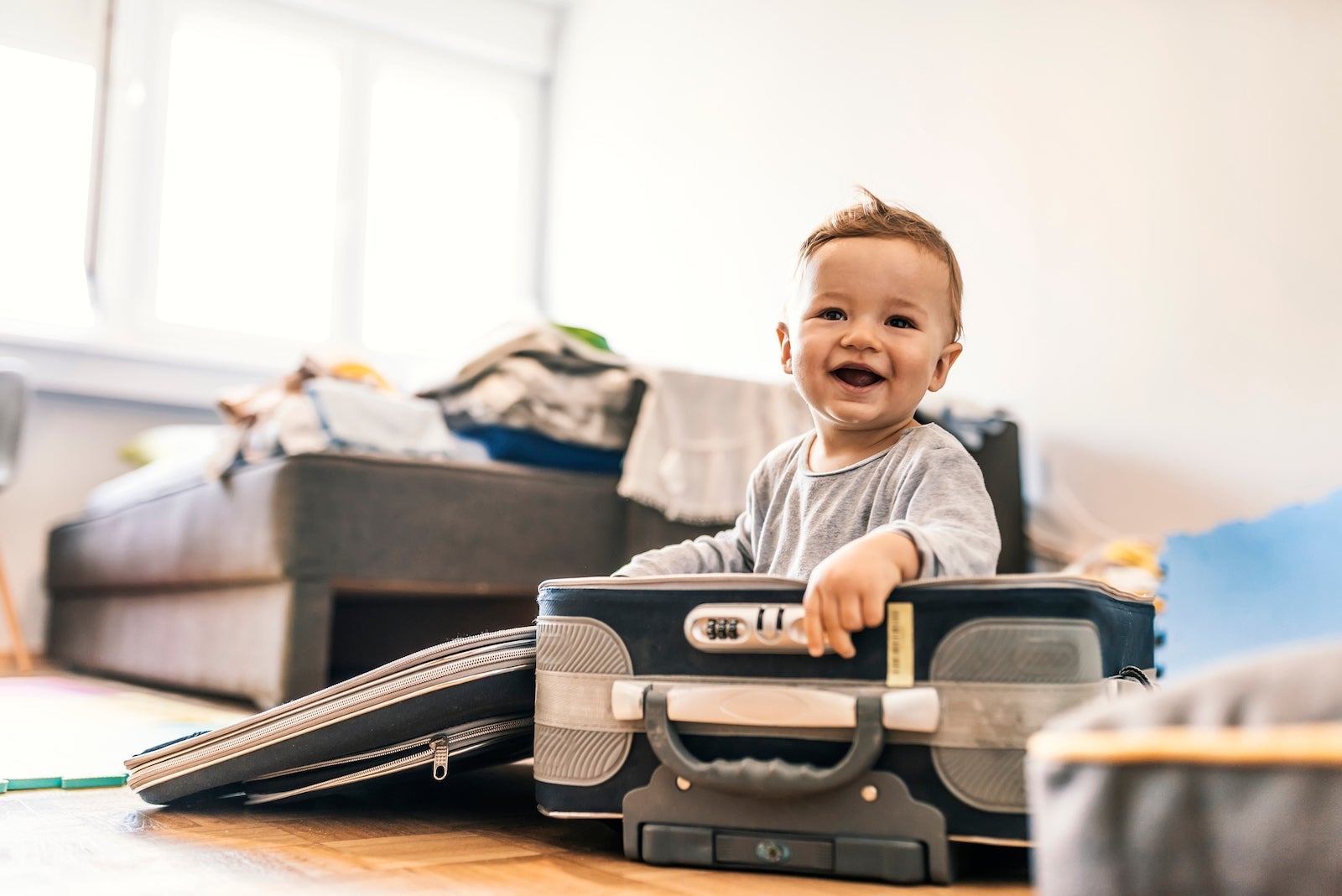 Adorable Baby Boy In Suitcase Having Fun