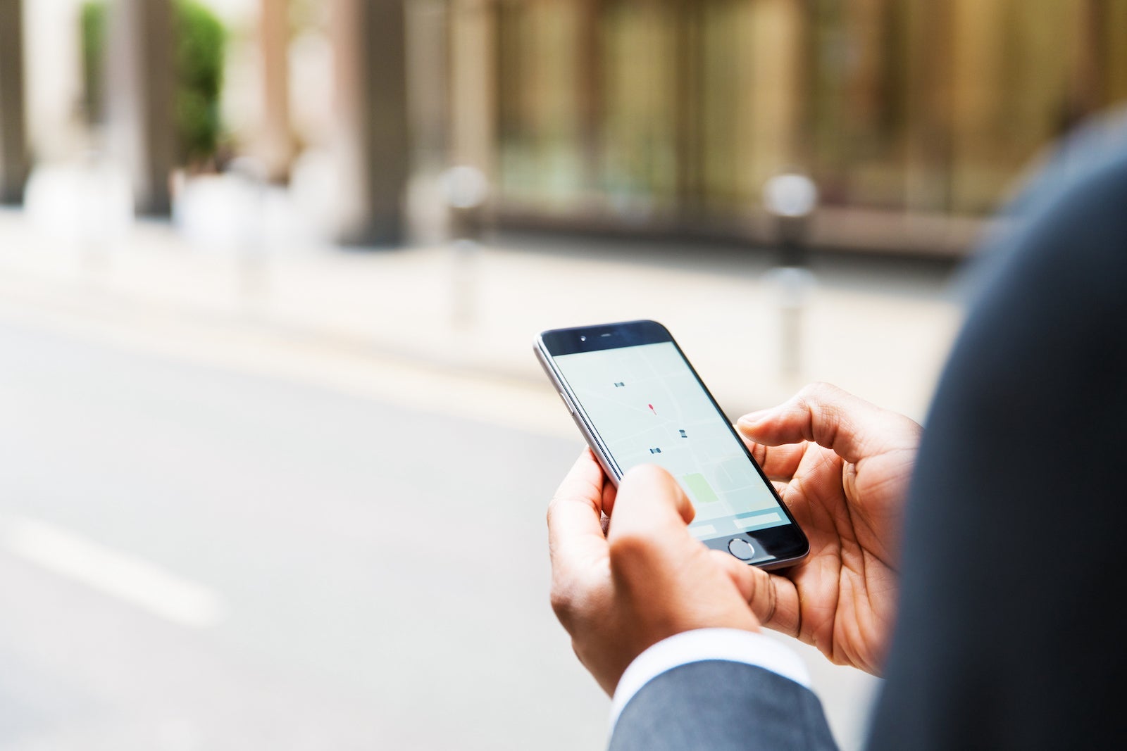 Close up of businessman using taxi app