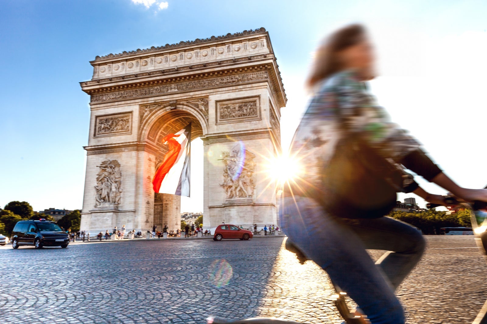 Arc de Triomphe in Paris with a big French flag under it