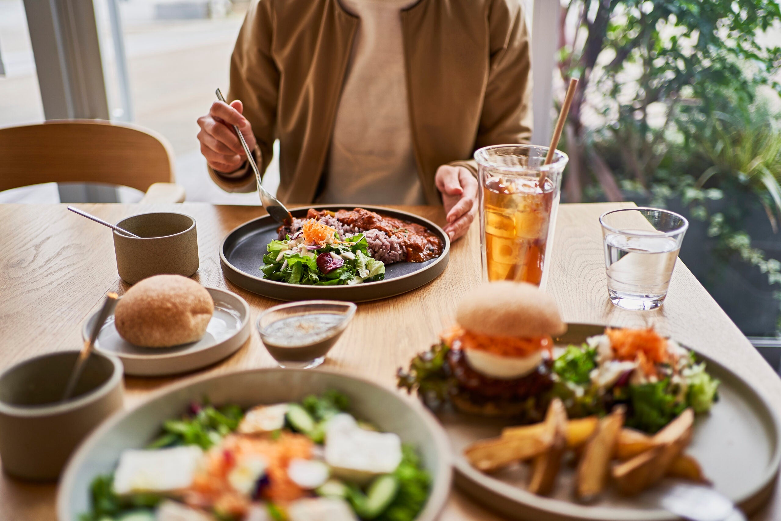 Scene at a table with a couple enjoying lunch at a vegan cafe.