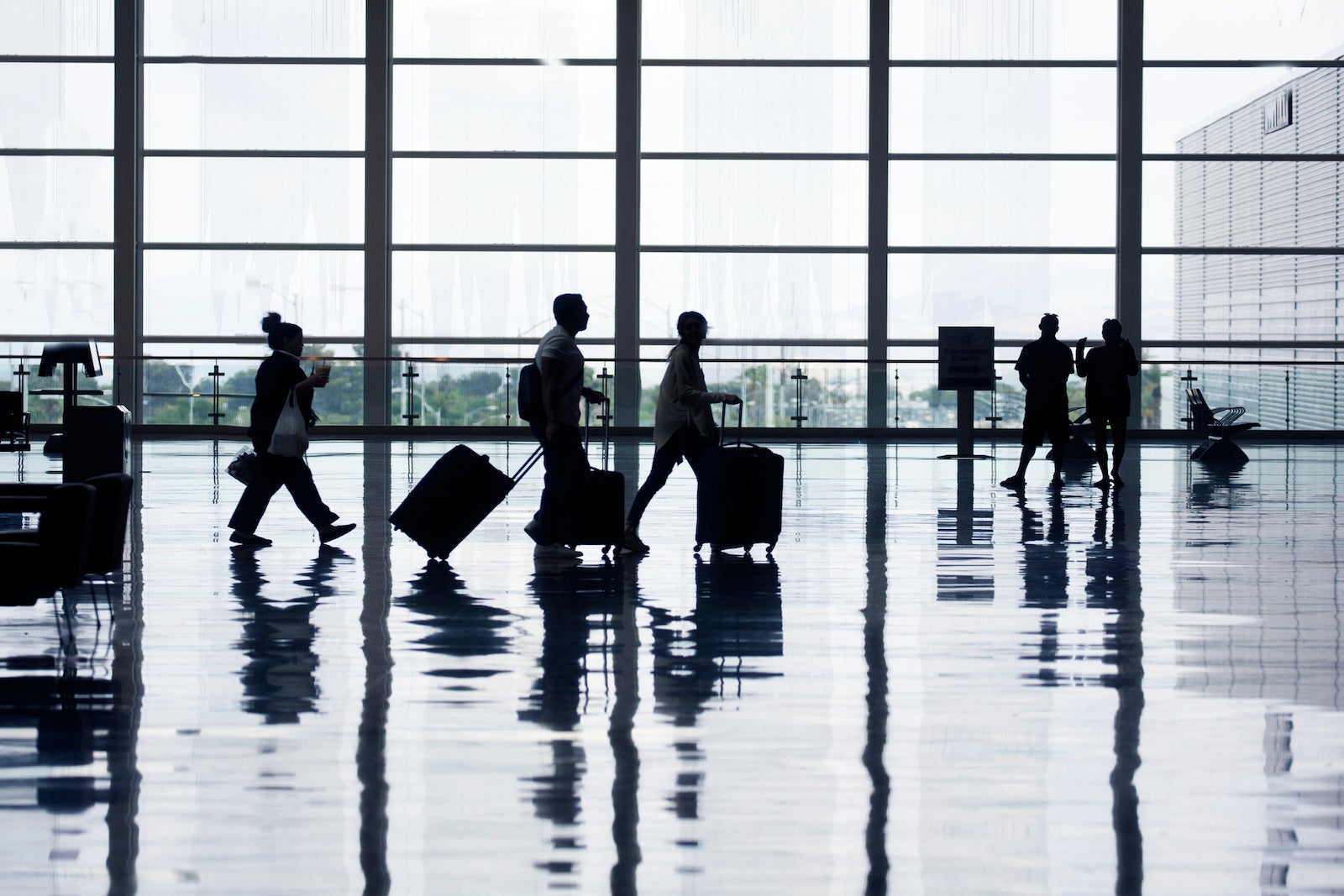View of airport departures area travellers rushing.