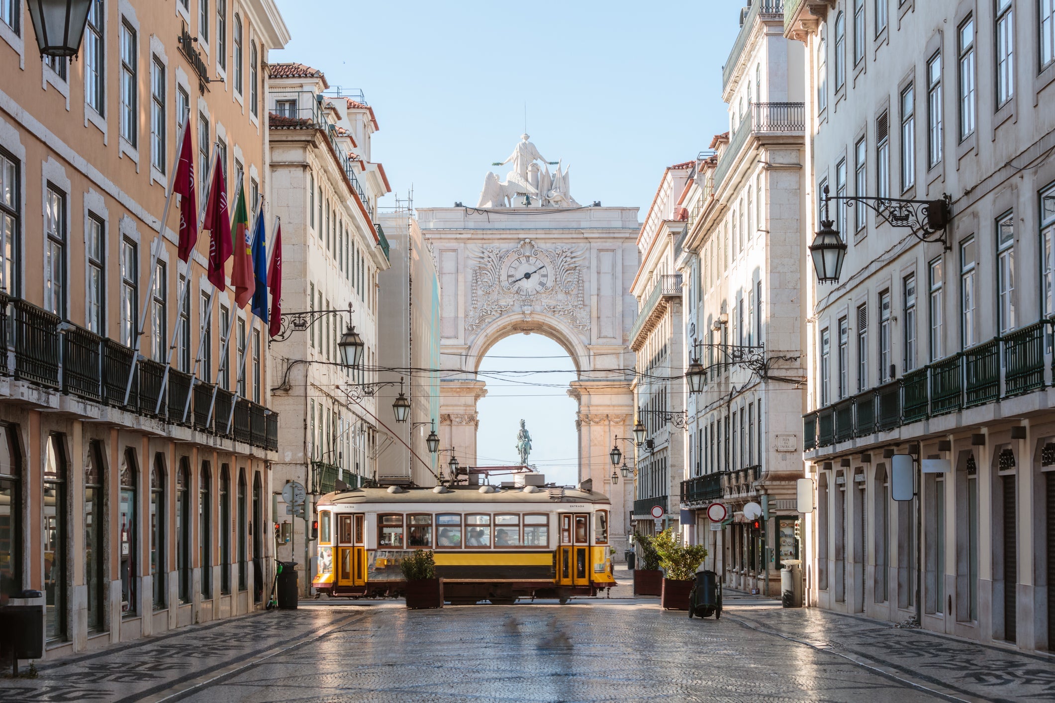 Tram in front of Rua Augusta arch, Lisbon, Portugal