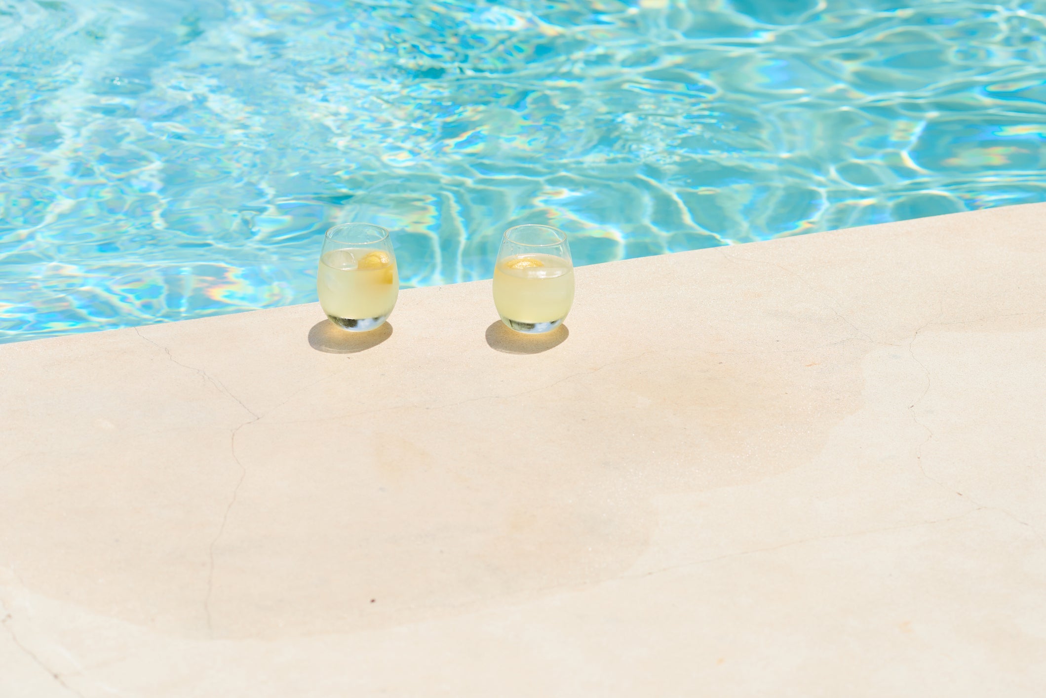 Two refreshing drinks sat poolside