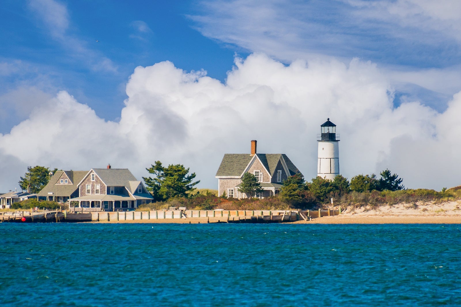 The lighthouse and cottage colony at the tip of Sandy Neck peninsula in Barnstable, Massachusetts