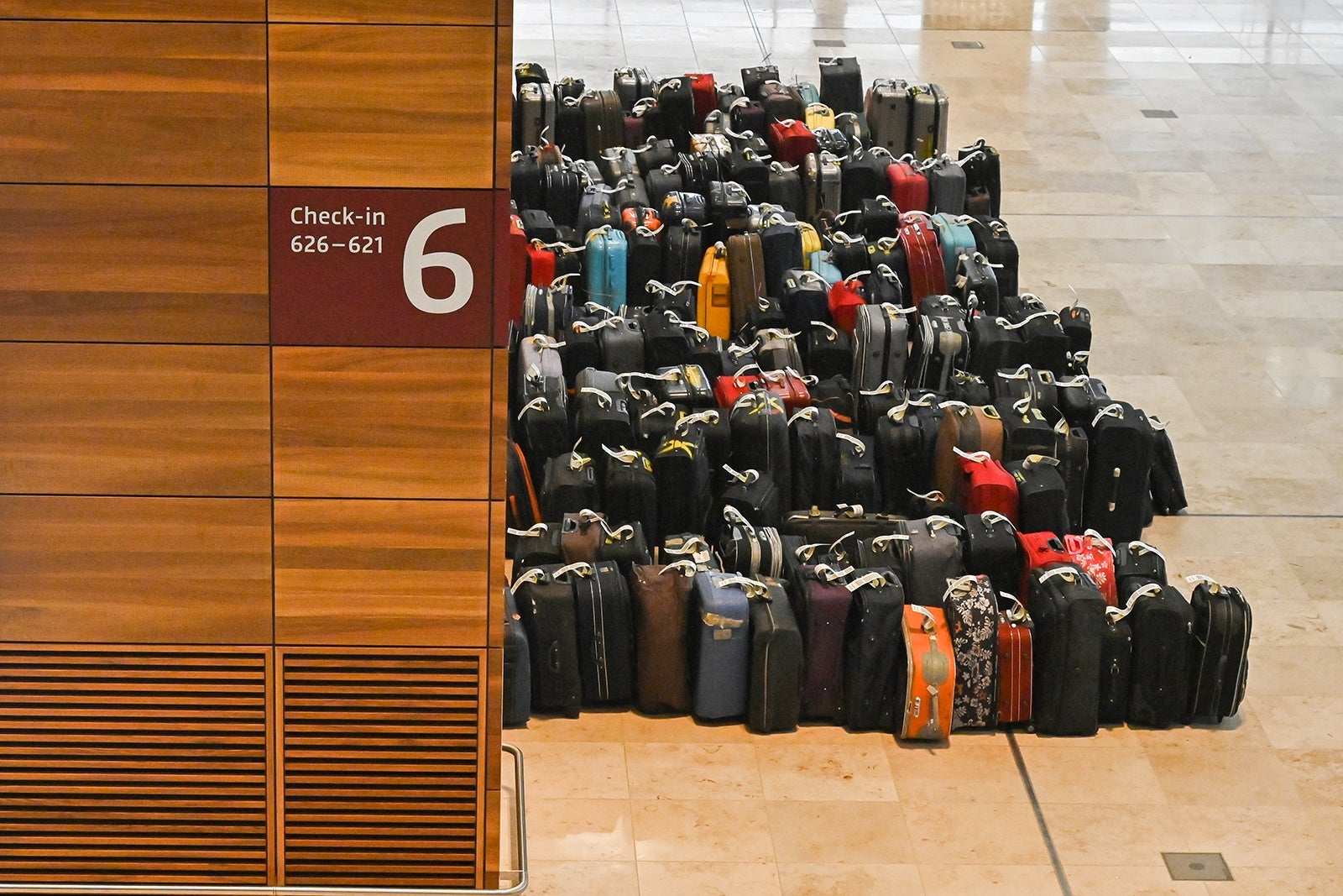 Suitcases to test the baggage carousel are piled at a check-in counter inside the entry hall to the Berlin-Brandenburg Willy-Brandt international Airport in Schoenefeld