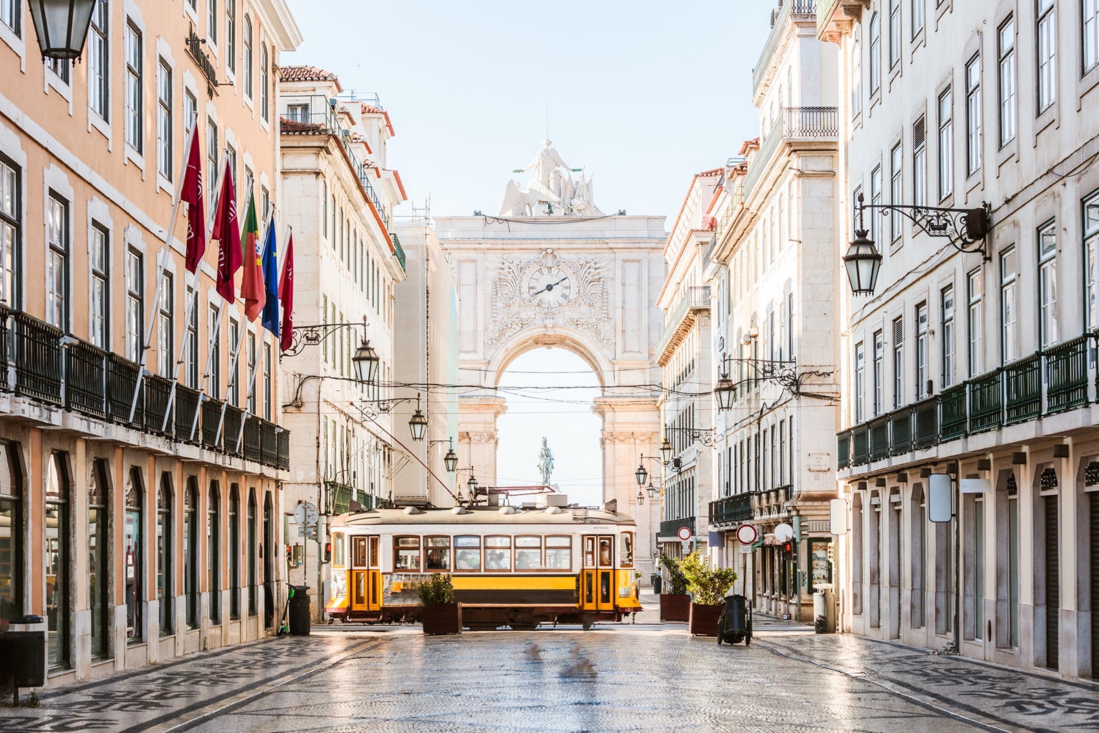 Tram in front of Rua Augusta arch, Lisbon, Portugal