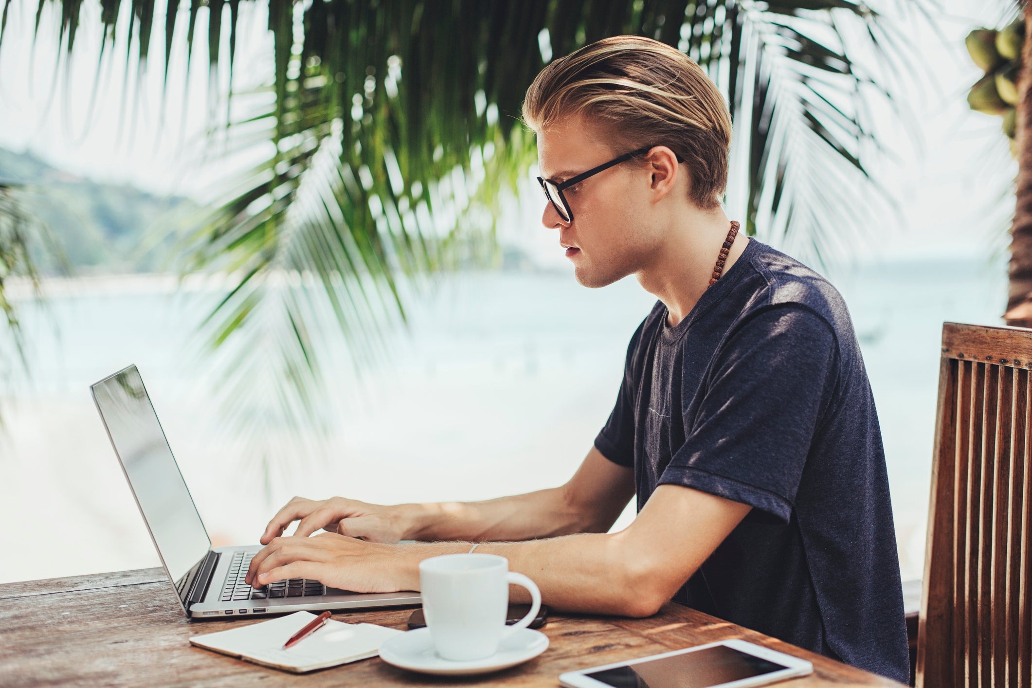 Caucasian man using laptop in cafe