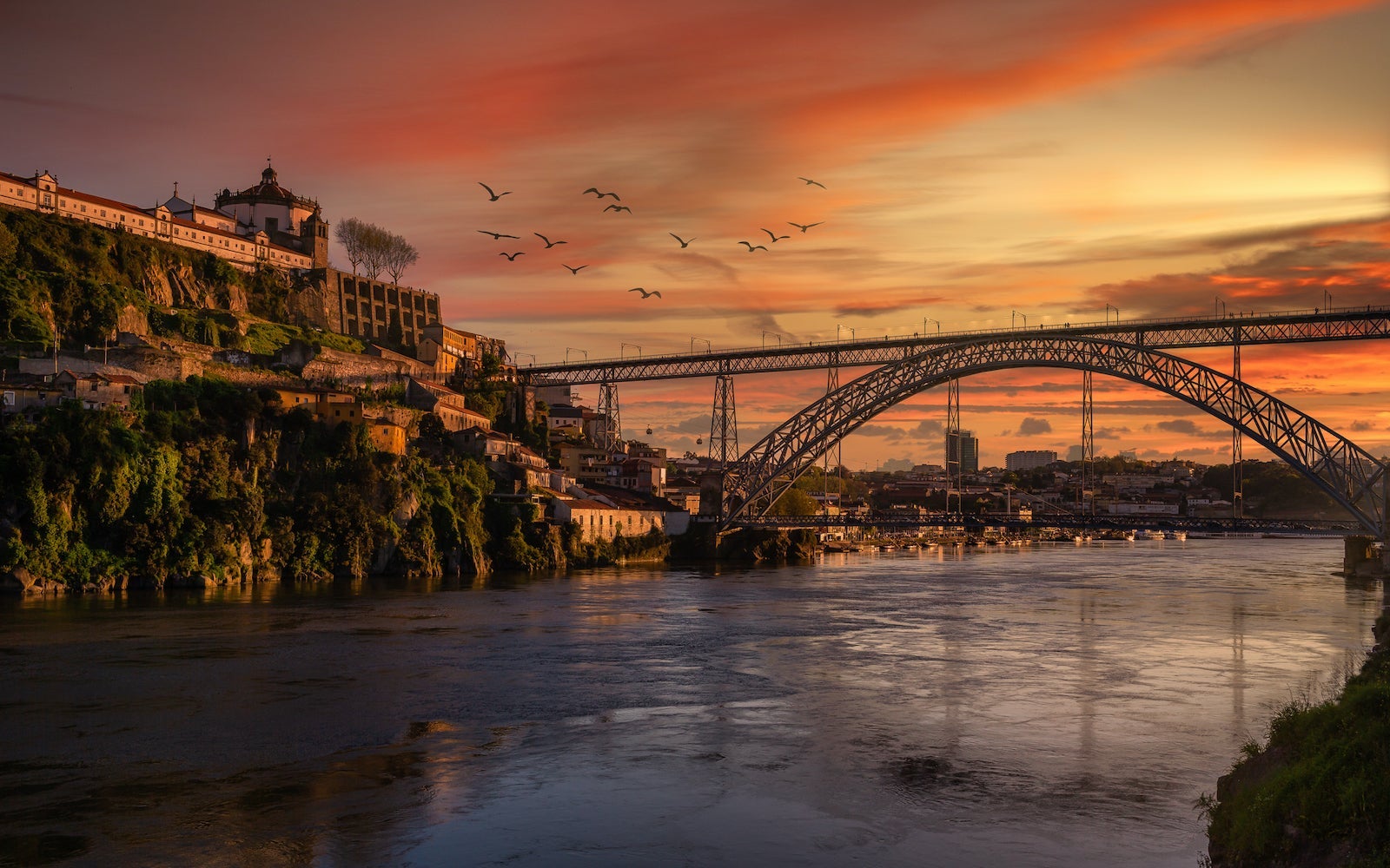 View of bridge over river against cloudy sky during sunset,Porto,Portugal