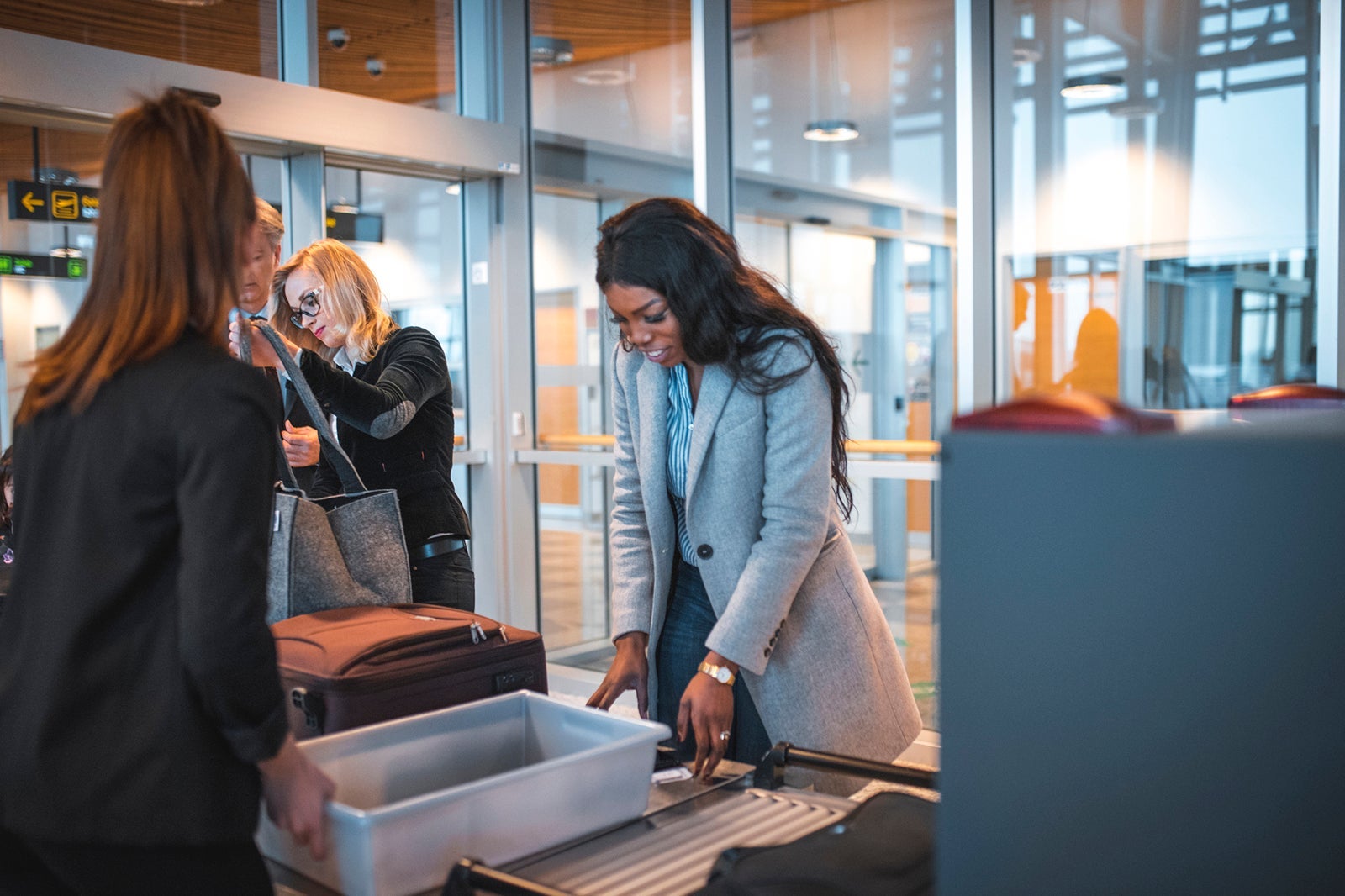 Passengers with luggage at security check
