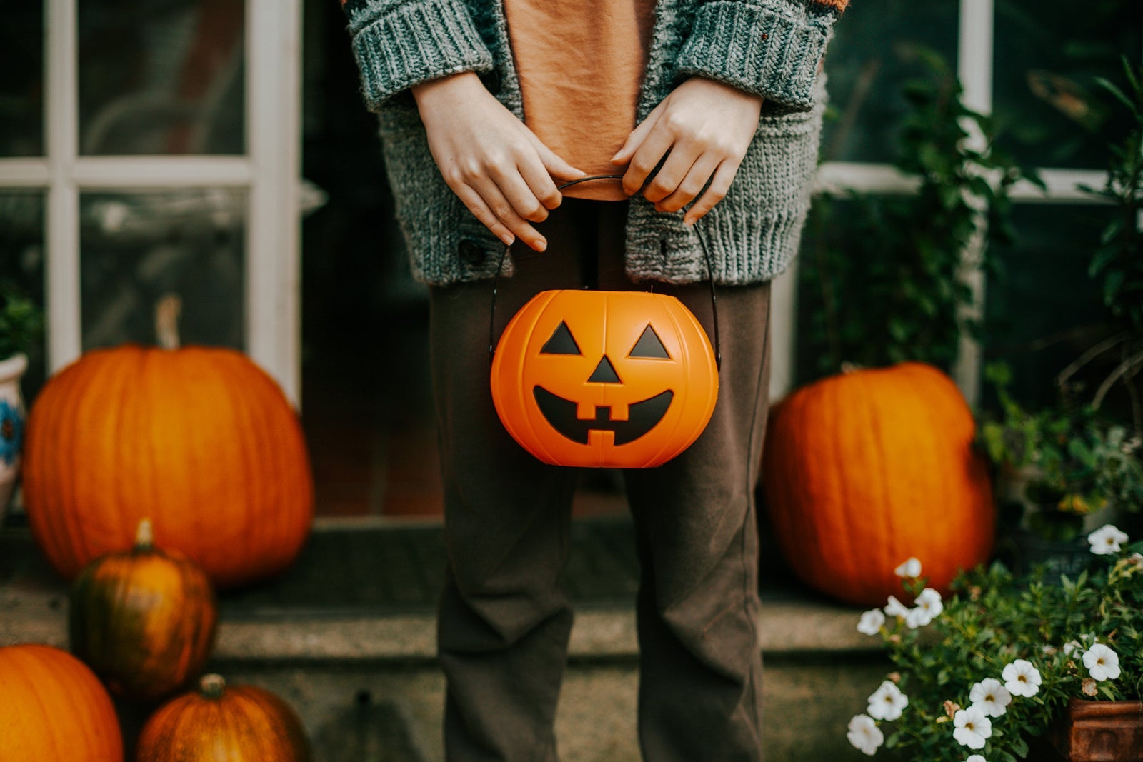 boy holding a halloween cup full of candies